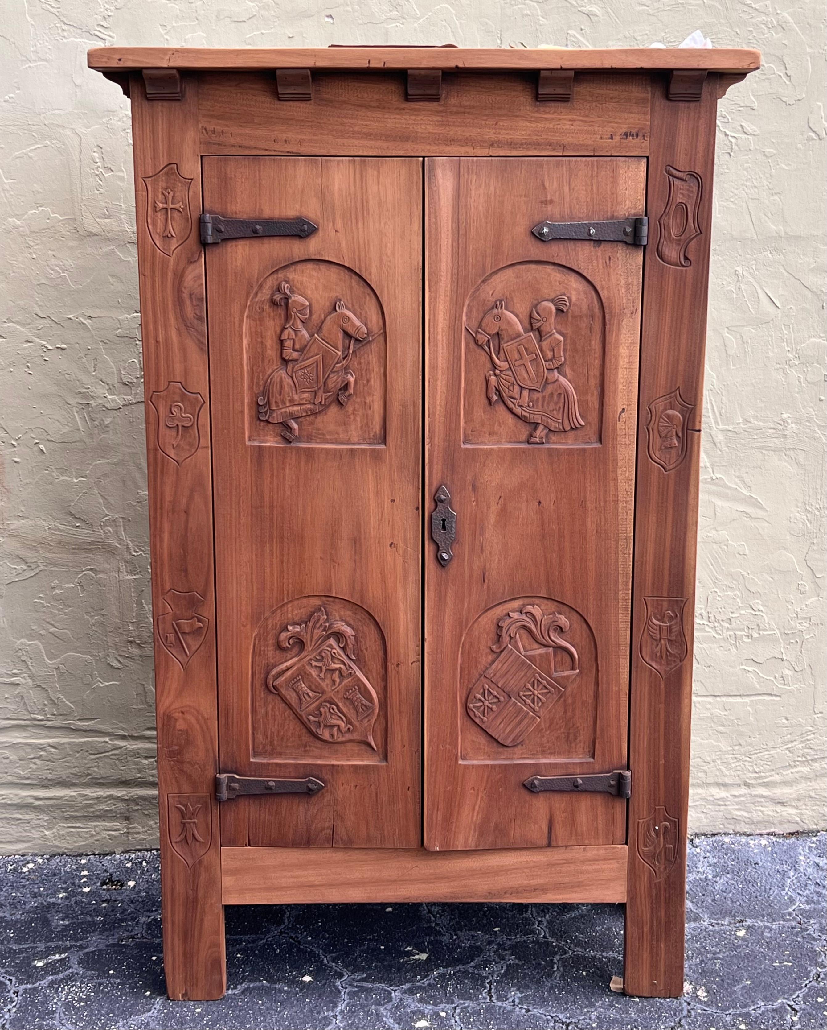 Spanish Gothic Style Walnut wardrobe with Five hangers and carvings
The doors features heads and symbols from gentlemen of this period. 
The original iron hardware makes so special this piece. 