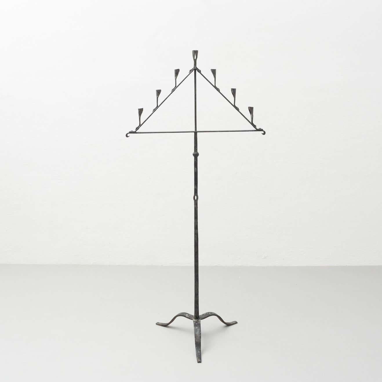 Spanish 'Hachero' traditional ancient wrought iron candleholder.  By unknown manufacturer from Spain, circa 1930.    In original condition, with minor wear consistent with age and use, preserving a beautiful patina.    Material:  Wrought iron   