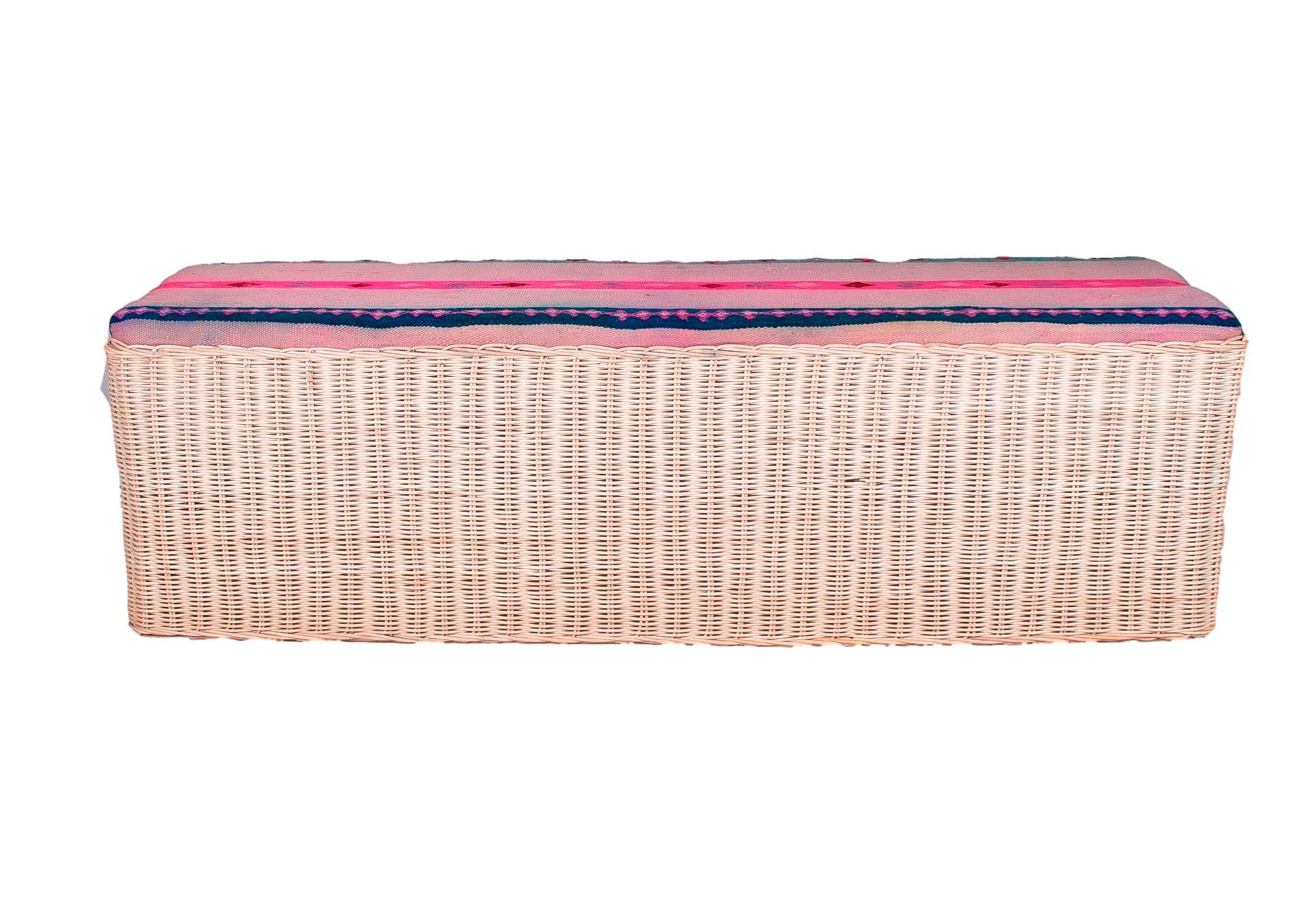 Spanish hand woven wicker bench with fabric upholstered seat.