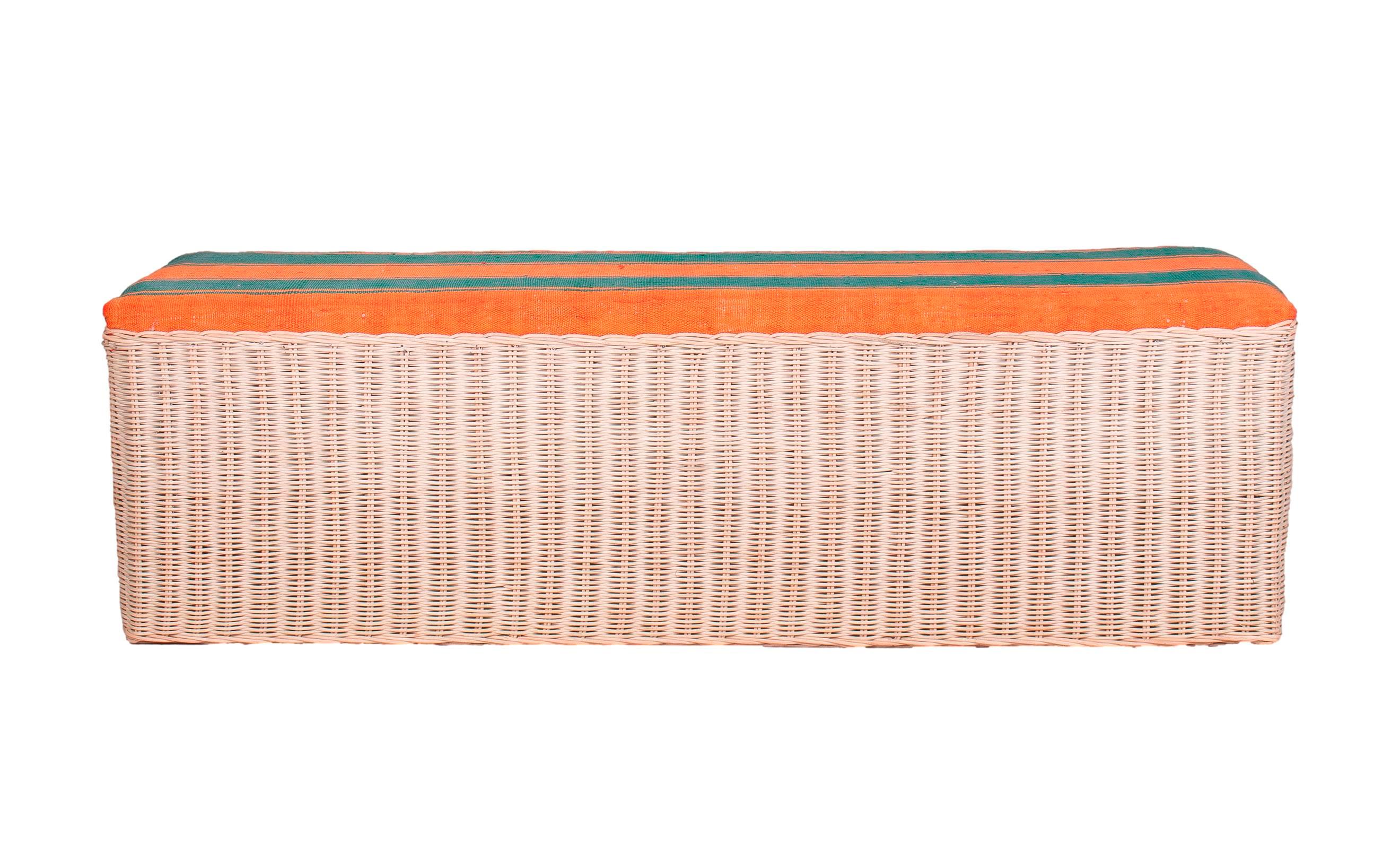 Spanish hand woven wicker bench with fabric upholstered seat.