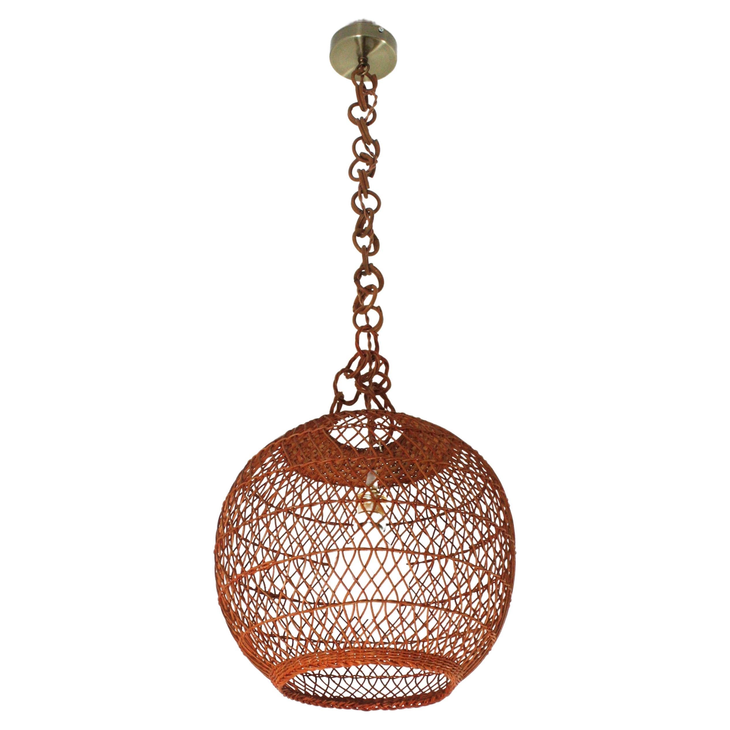 Large Globe Pendant Lamp, Wicker, Rattan
Eye-catching handcrafted braided rattan / wicker pendant hanging lamp. Spain, 1960s.
This beautiful suspension lamp features a hand-woven wicker globe shaped lampshade. It hangs from a chain with  rattan