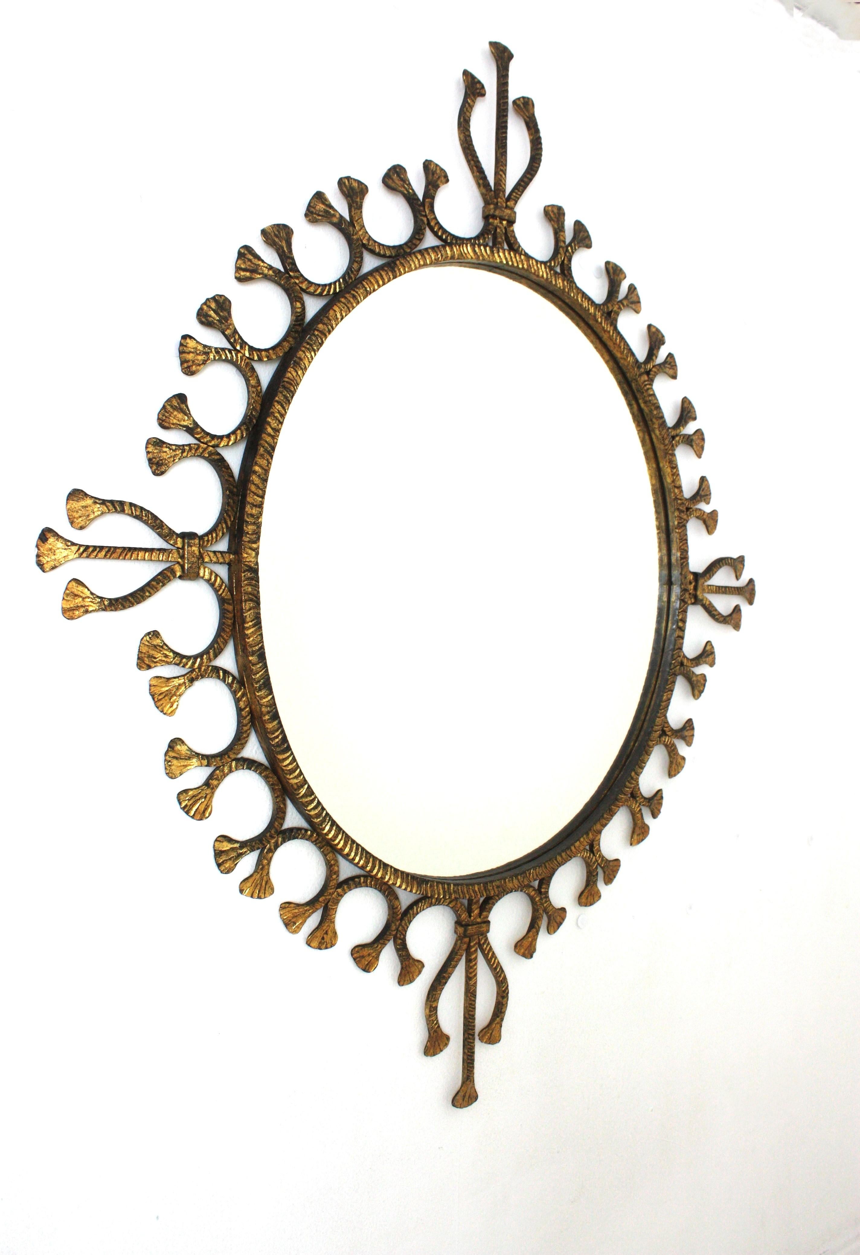 Mid-Century Modern Spanish Hollywood Regency Gilt Wrought Iron Oval Sunburst Mirror / Wall Mirror For Sale