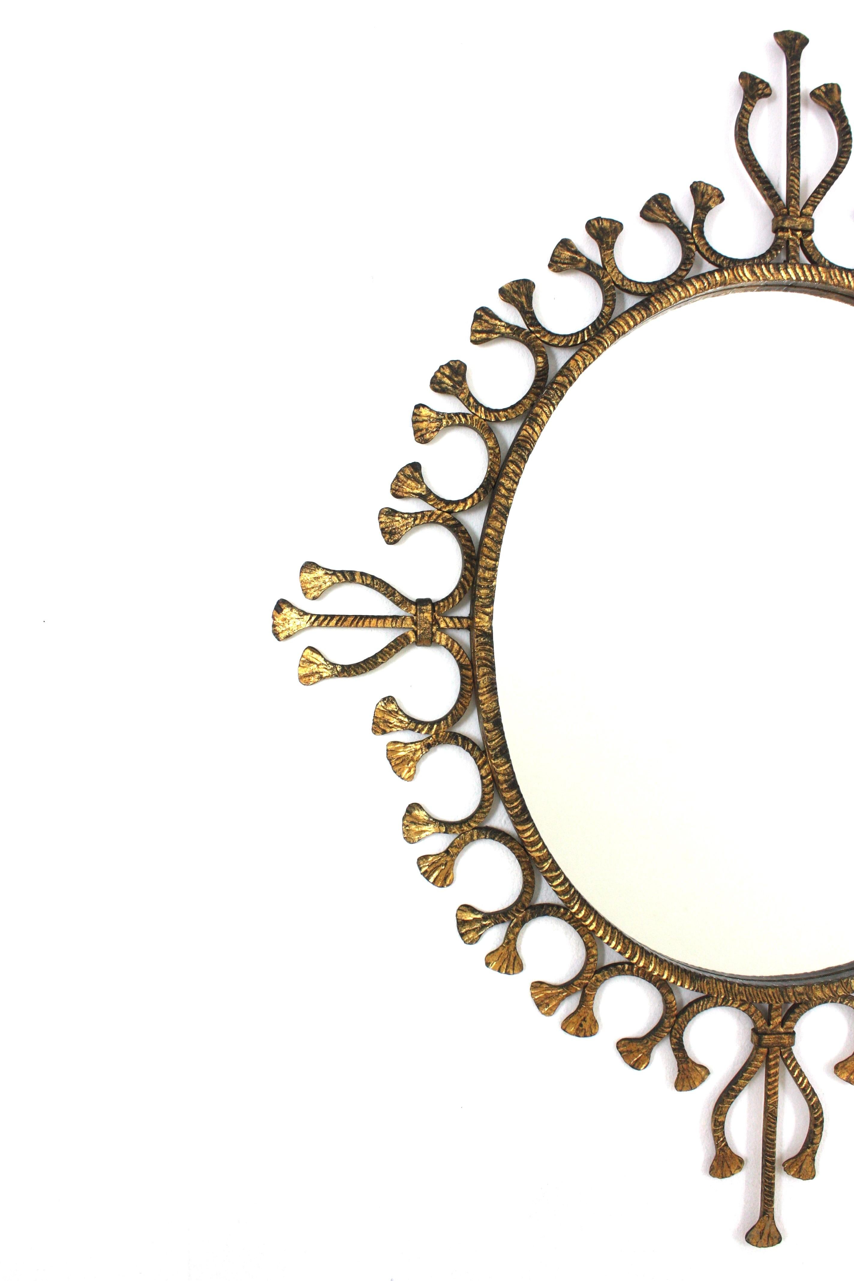 20th Century Spanish Hollywood Regency Gilt Wrought Iron Oval Sunburst Mirror / Wall Mirror For Sale