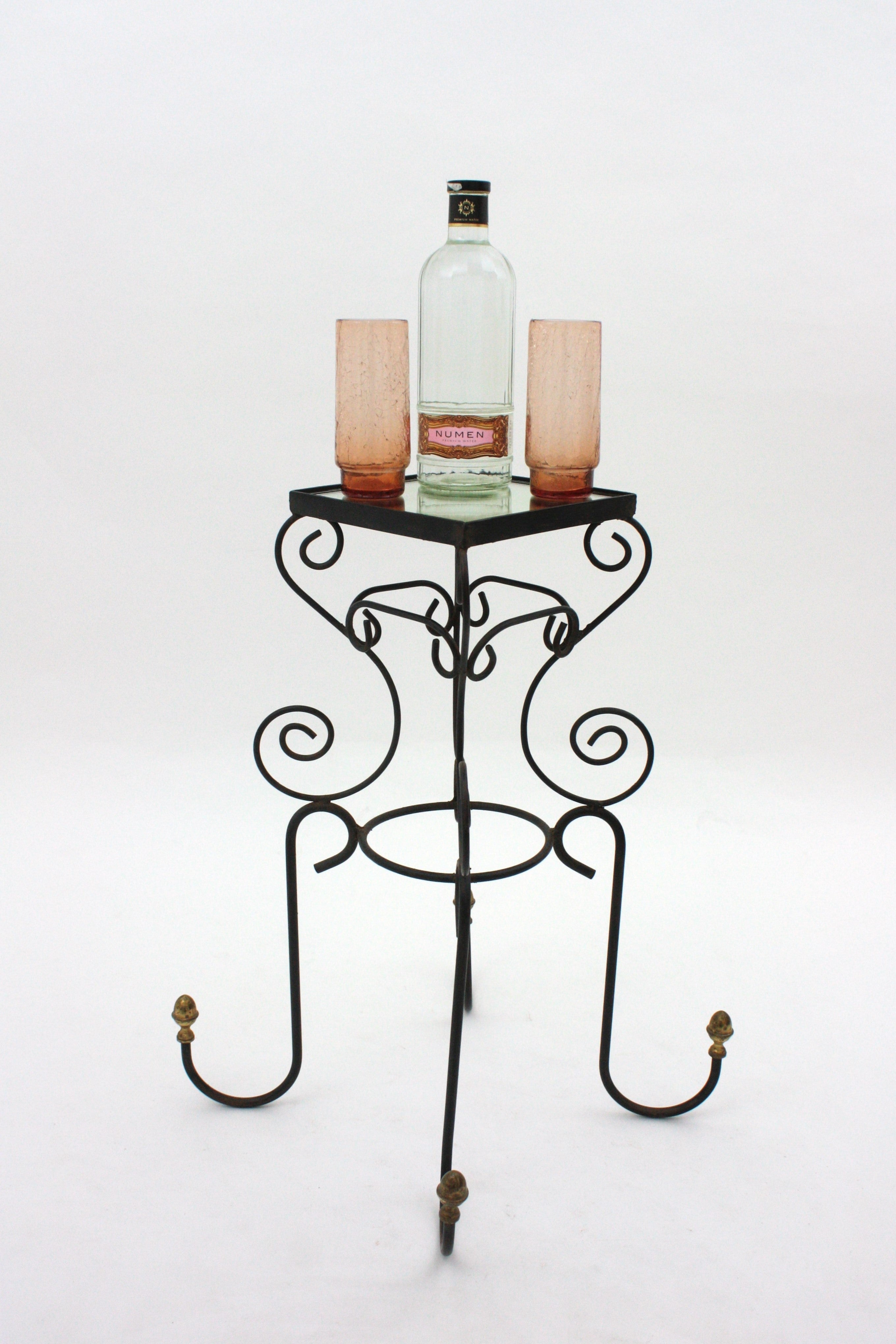 Wrought Iron Scroll Work Table with Brass Accents and Mirror Top, Spain, 1950s
This hand-crafted table was manufactured by a well-known Spanish maker. It is heavily scrolled creating an ey-catching design. It stands on four feet ended by brass