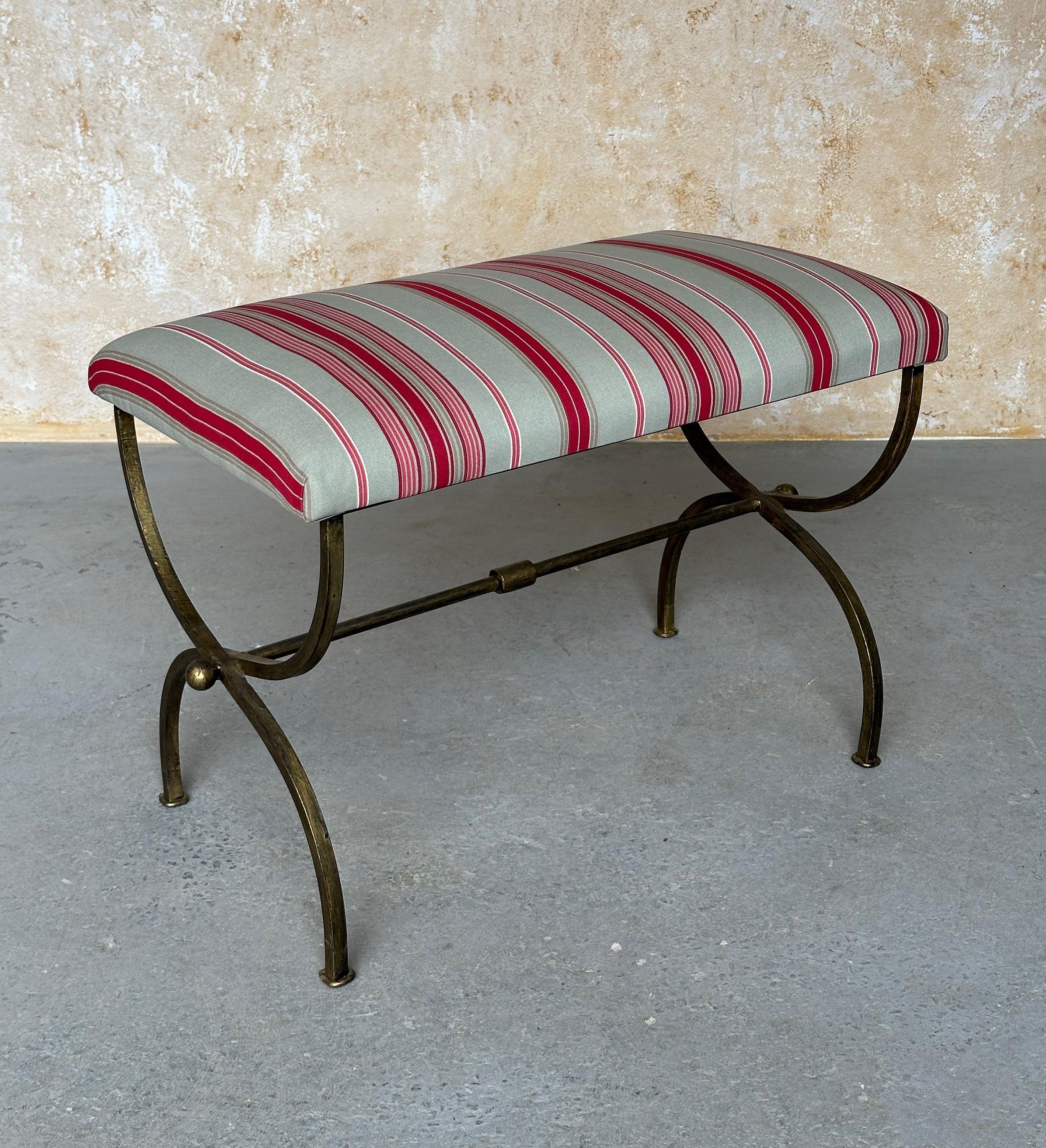 This elegant Spanish iron bench was recently made by skilled European craftsmen using traditional iron working techniques. It features gracefully curved legs and a central stretcher with a decorative central ring detail and spheres at the ends. The