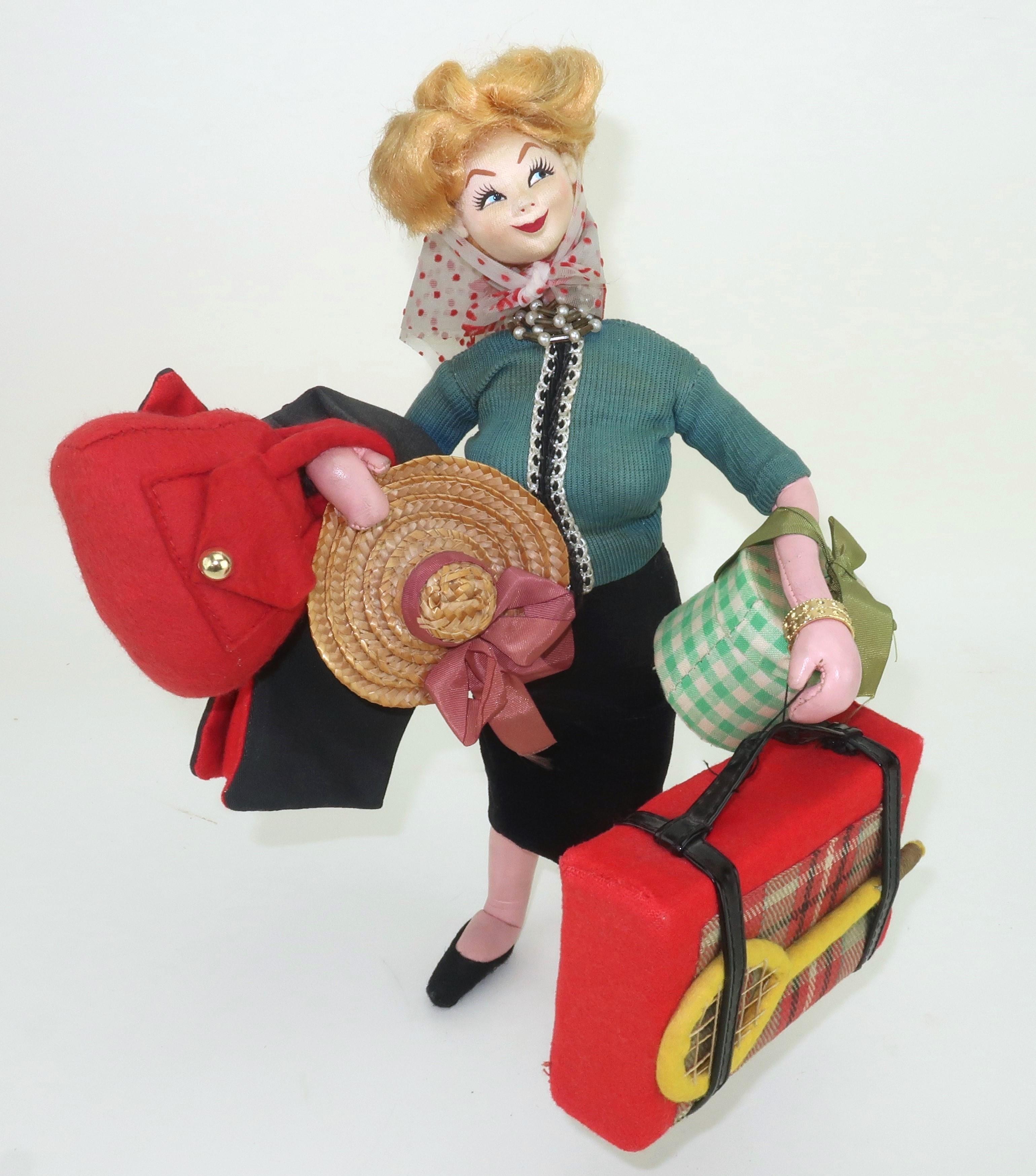 Wildly whimsical Spanish doll created in the 1950's by Klumpe Roldan for the tourist market.  This highly animated doll depicts a traveler laden with luggage, sporting goods, handbags and an adorable countenance.  It's like 'I Love Lucy' goes on