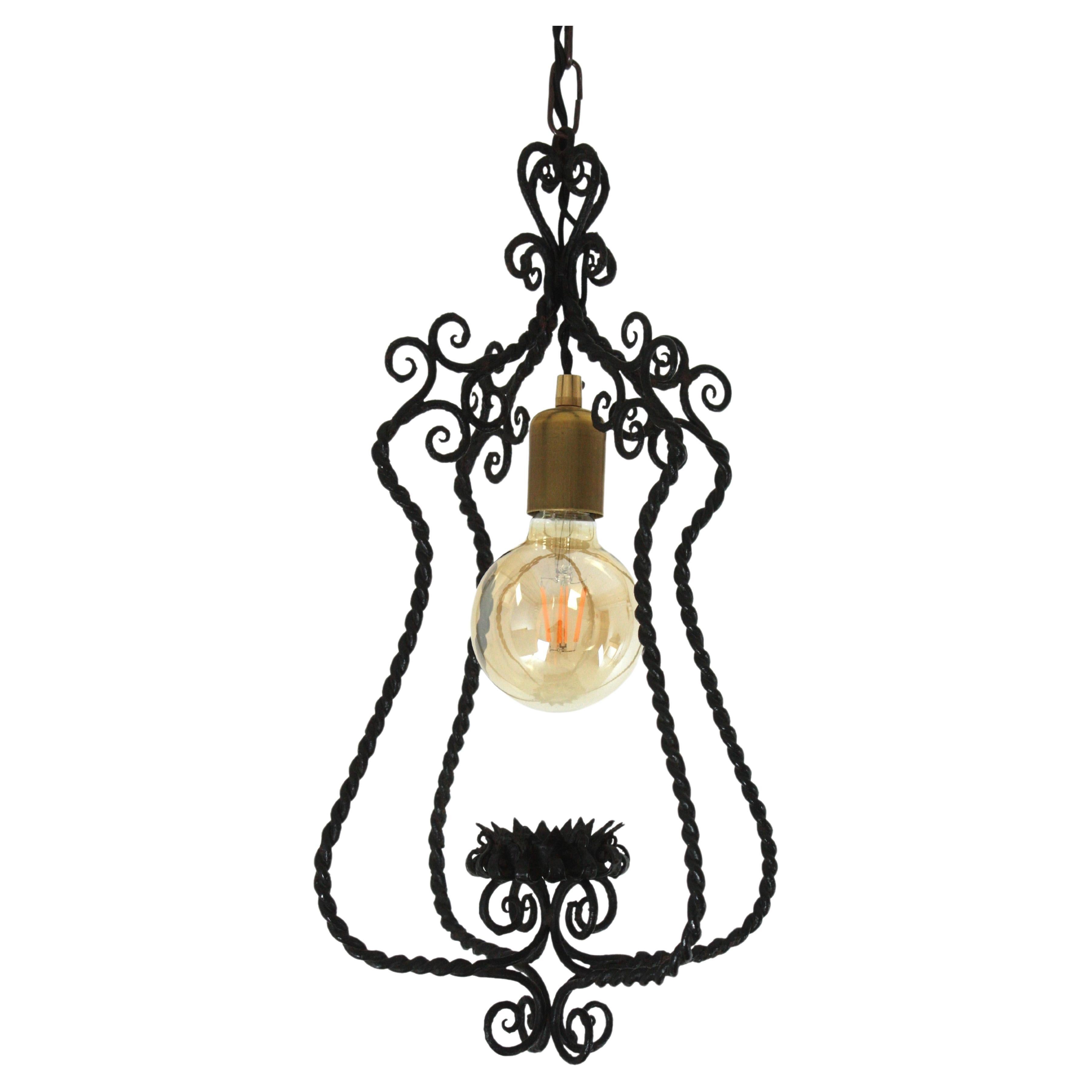 Spanish Revival Lantern Chandelier in Twisted Hand Forged Iron, 1940s
Eye-catching scrollwork lantern or hanging light with twisted iron construction.
The structure of this pendant light is made with twisting iron with scroll decoration at the top