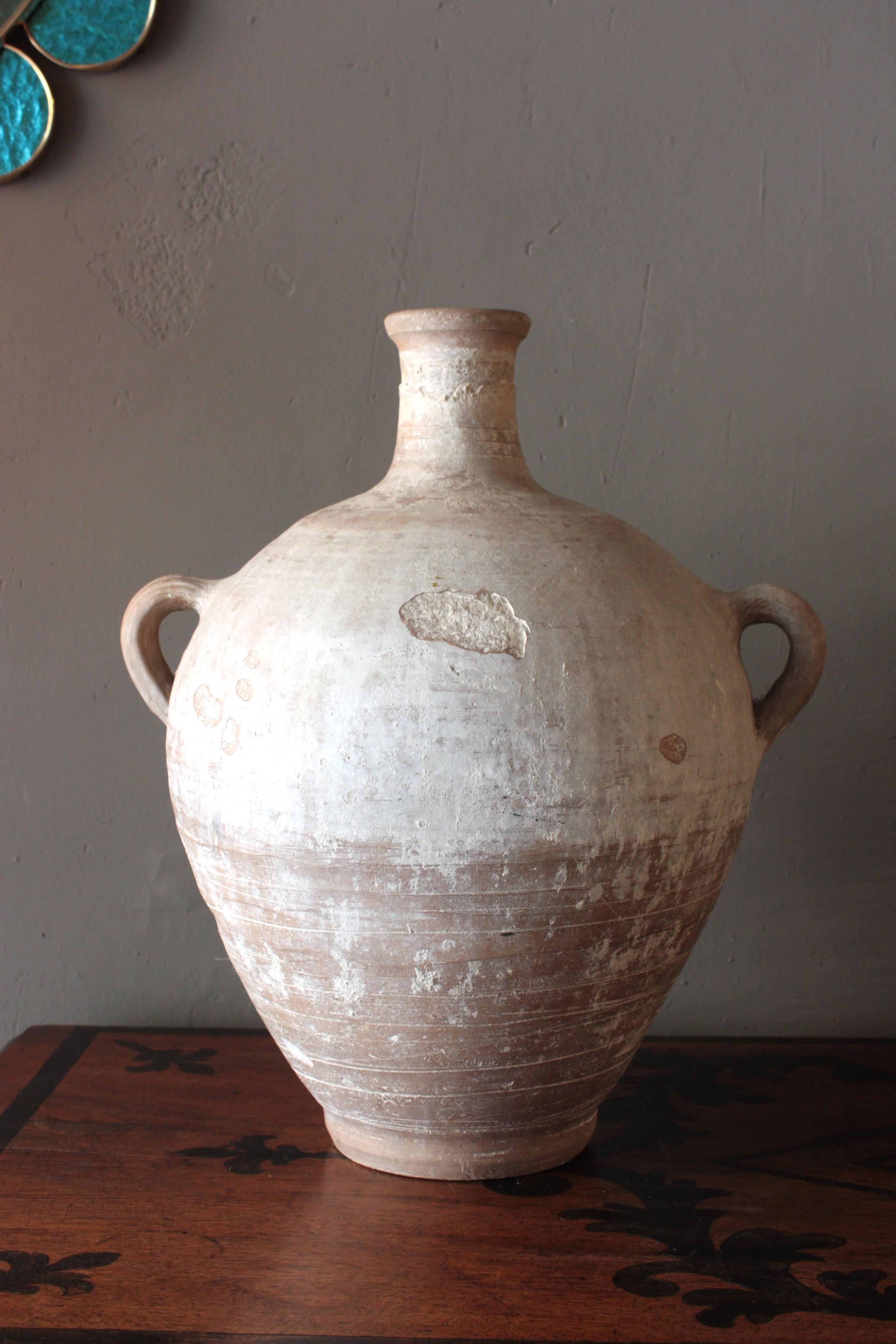 Andalusian Hand-made terracotta two-handled water jar, Spain, 1880s-1930s.
Traditional spanish terracotta jar / pitcher. Unglazed exterior and interior with handles at both sides. Used as water containers. 
Traditional rustic pottery manufacture