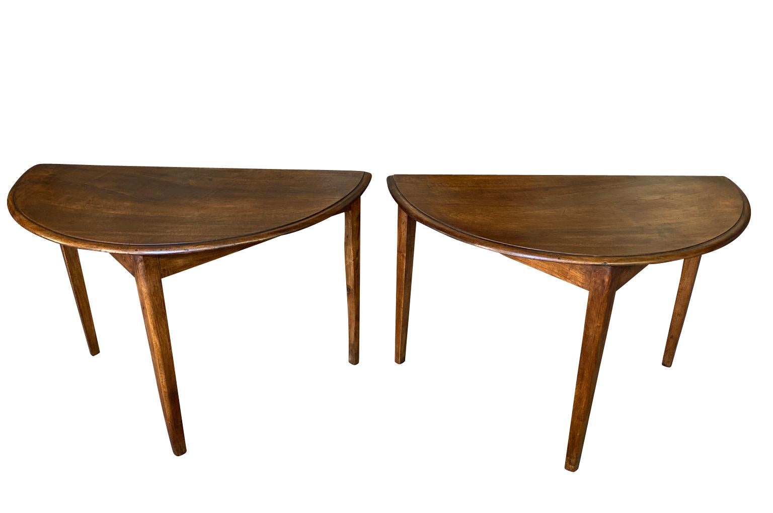 A very handsome late 19th century pair of Demi Lune Console Tables from Spain.  Beautifully constructed with very minimalist lines from walnut.  