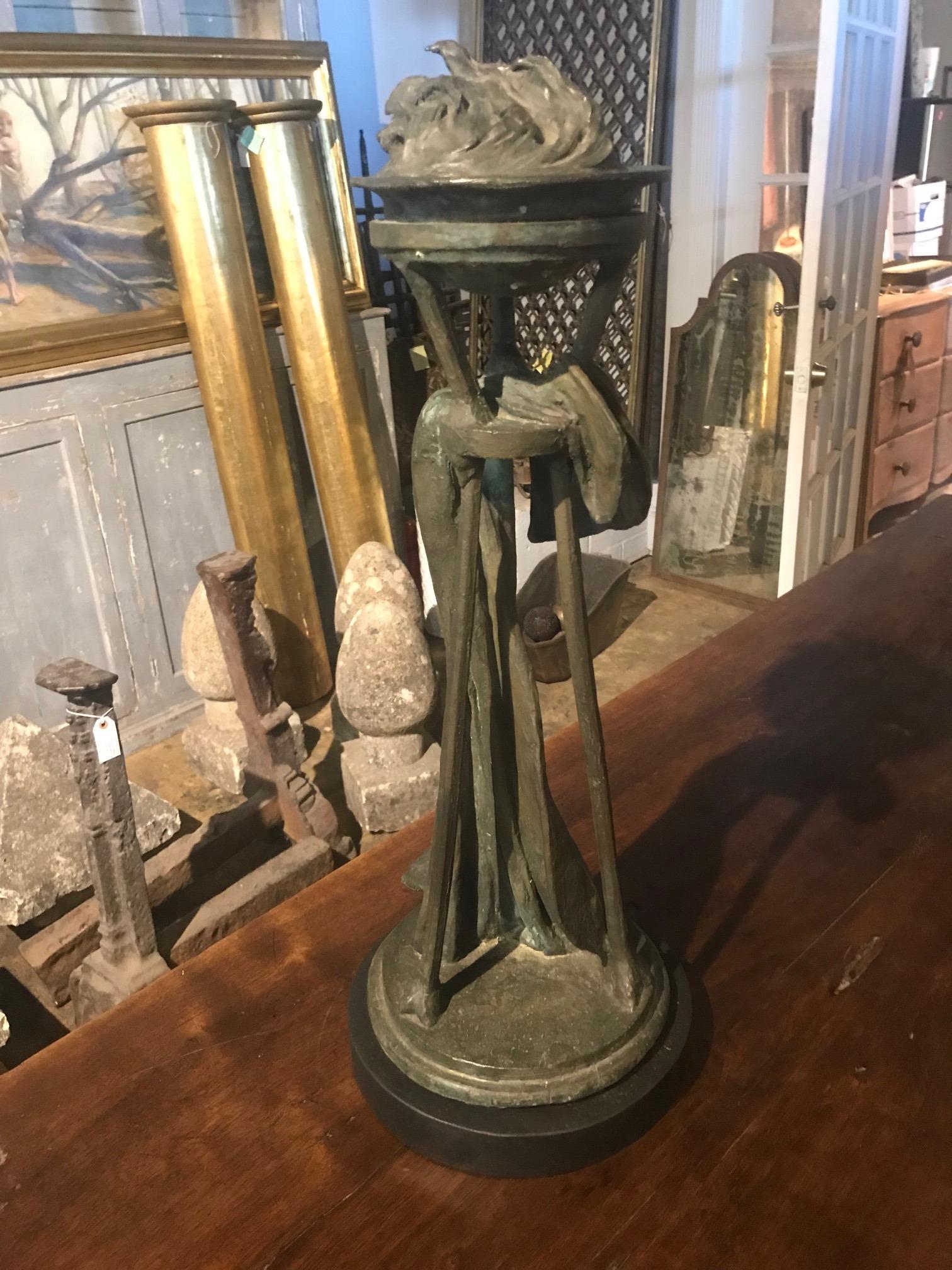 A stunning later 19th century architectural sculpture of flame finial exquisitely cast in bronze. The sculpture is now presented on its custom made iron base.