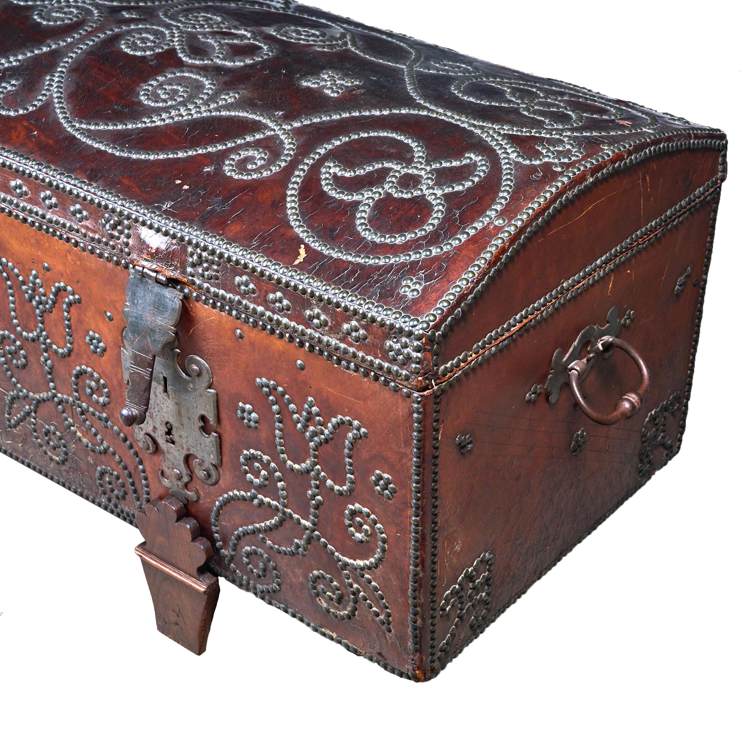 The best leather and studded decorative trunk on original stand. Rare and in excellent condition. Wonderful color and patina. 

