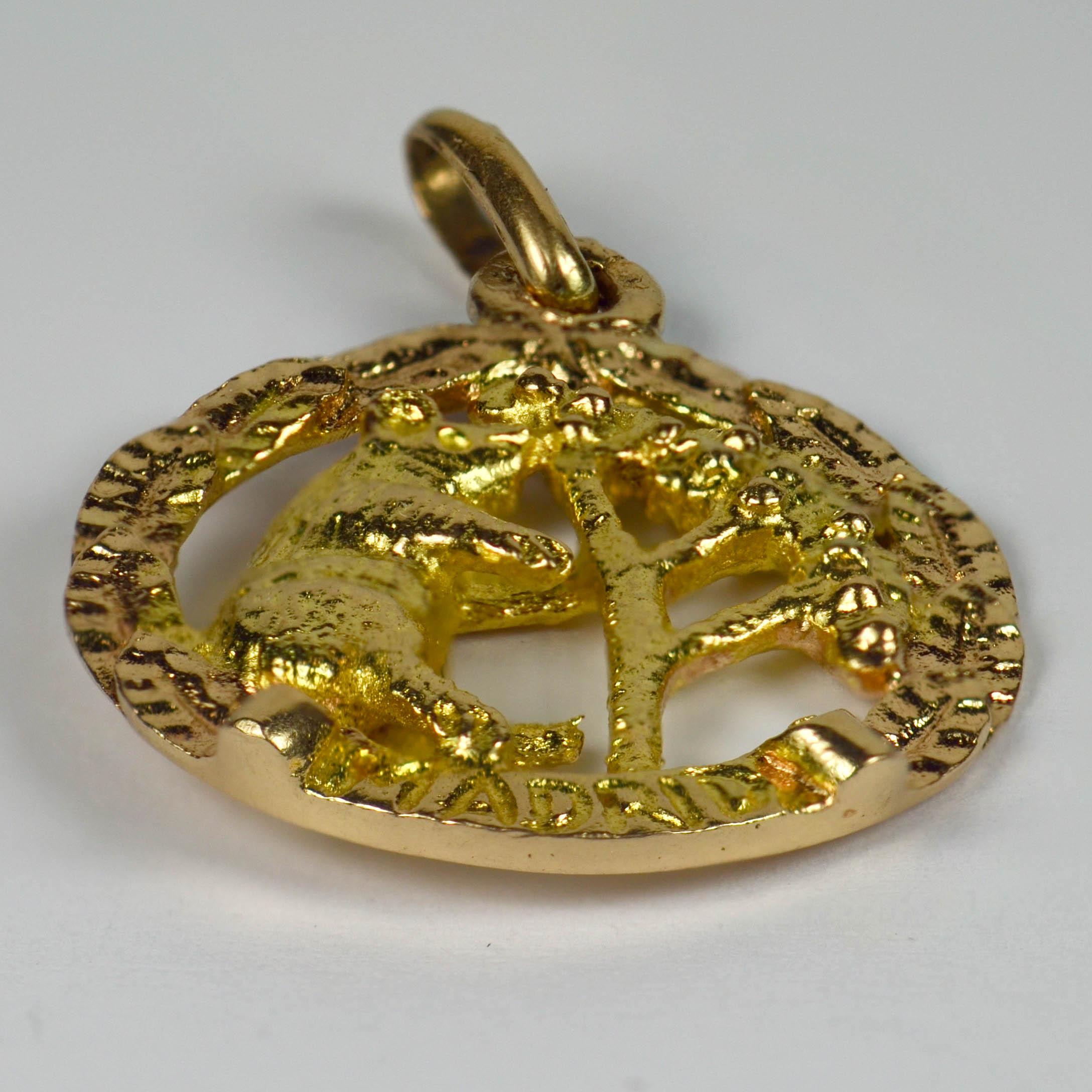 An 18 karat yellow and rose gold charm pendant depicting the official symbol of Madrid - El Oso y el Madrono (The Bear and the Strawberry Tree) within a wreath of leaves. 
Unmarked but tested as 18 karat gold.

Dimensions: 2.5 x 1.8 x 0.3 cm
Weight: