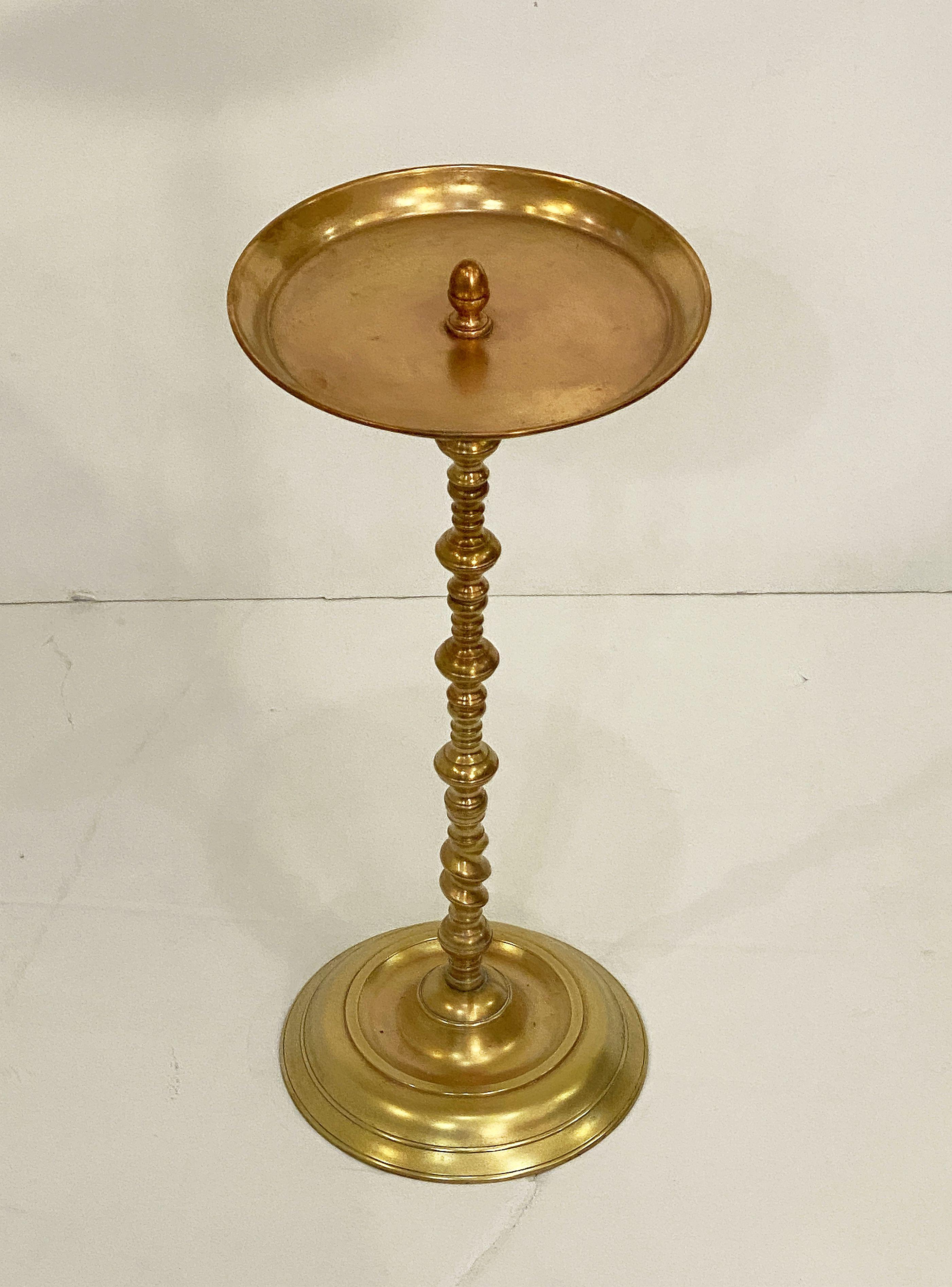 A fine Spanish martini or drinks table of a heavy brass and copper, featuring a round top finial-mounted to a turned brass pedestal column and circular base.

Great as a cocktail table or end table as well.


