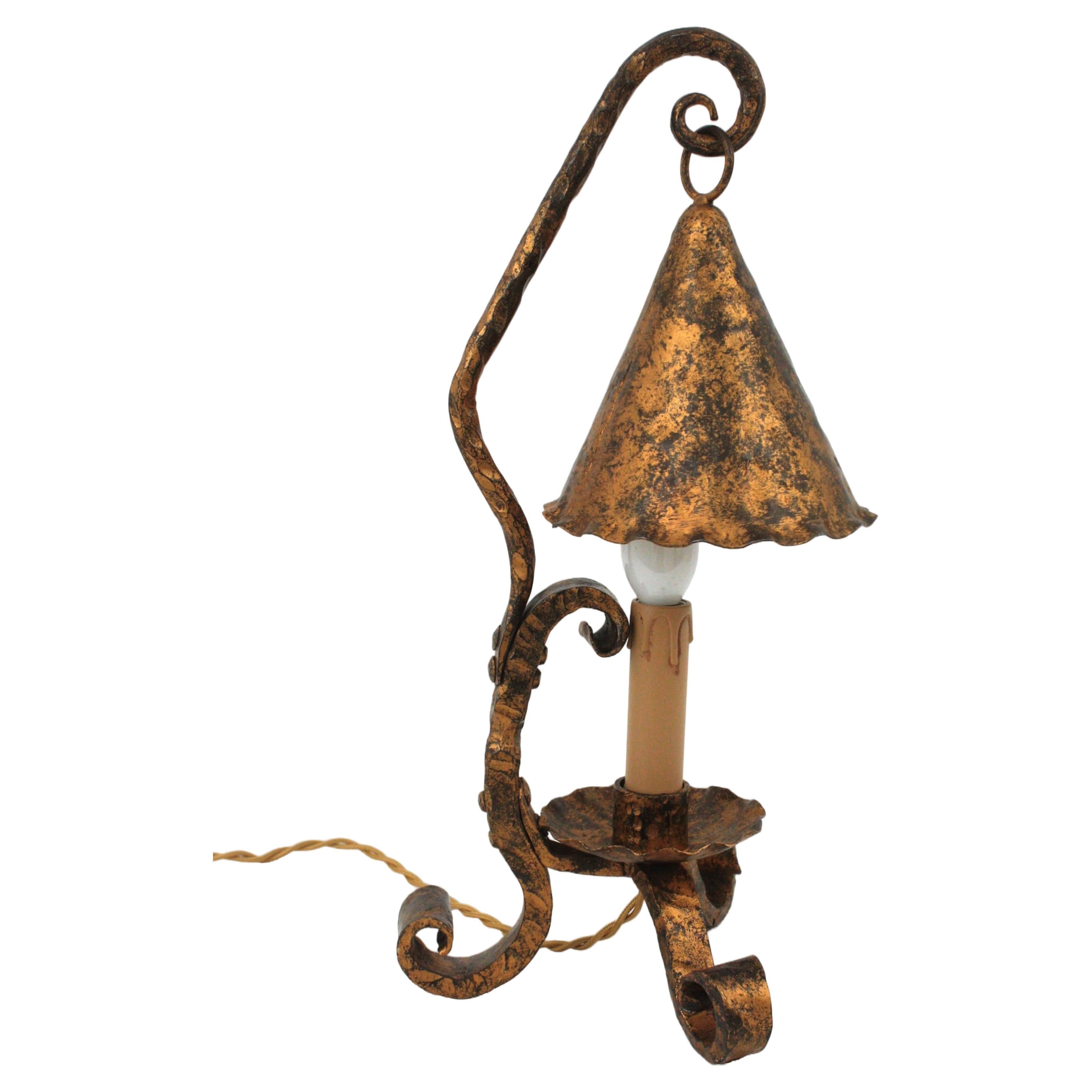 Medieval Style Iron Table Lamp, Spain, 1940s
Gorgeous Spanish Colonial table lamp hand forged in iron with gilt patinated finsih.
Tripod standing piece with scroll work ending feet. Its design inspired in candle lights features a conical iron