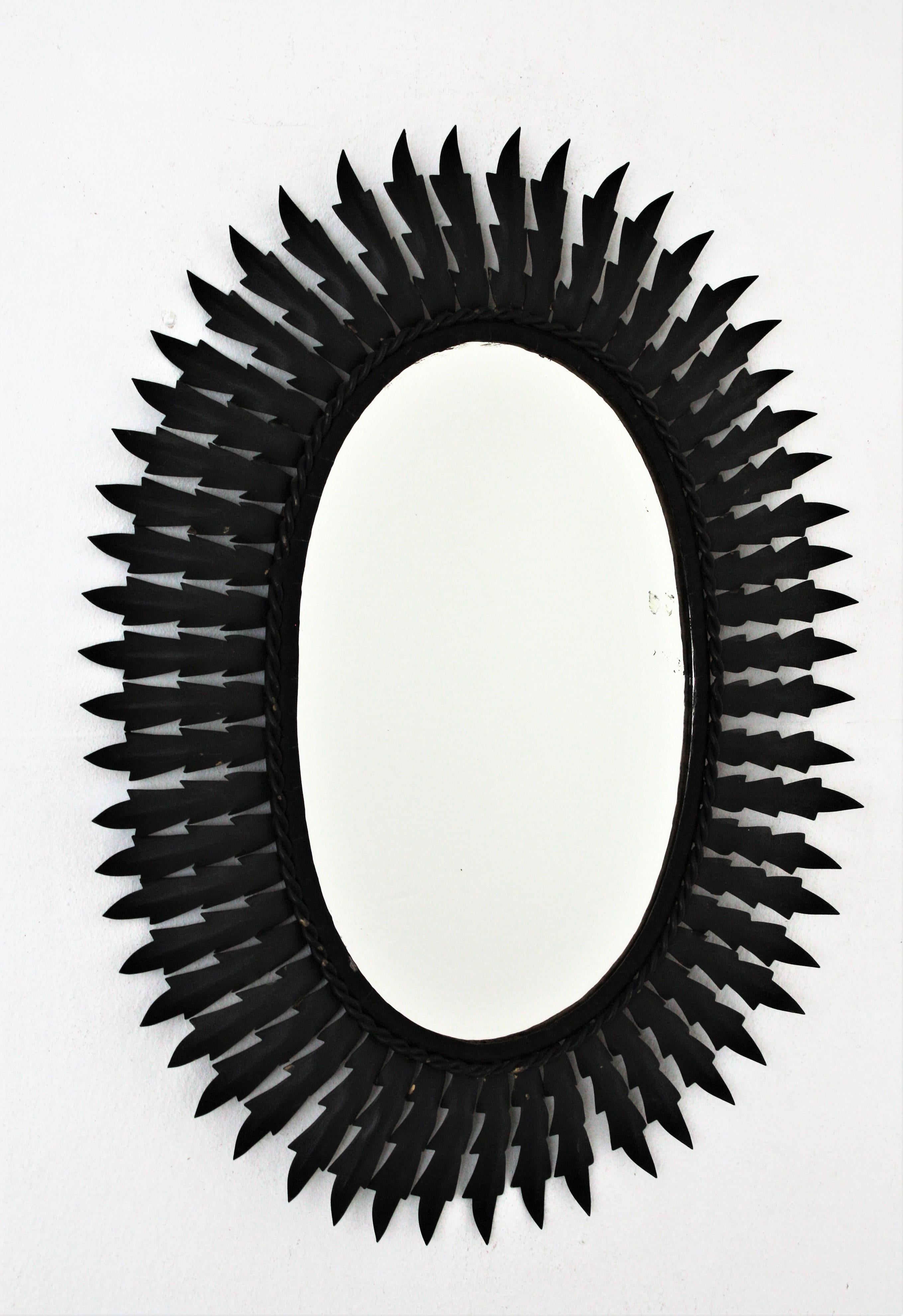 An eye-catching oval sunburst mirror handcrafted in metal with black matte painted finishing. Spain, 1960s.
This wall mirror would be a nice addition wherever you place it, alone or as a part of a wall composition.
Measures: 60 cm H x 47 cm W //