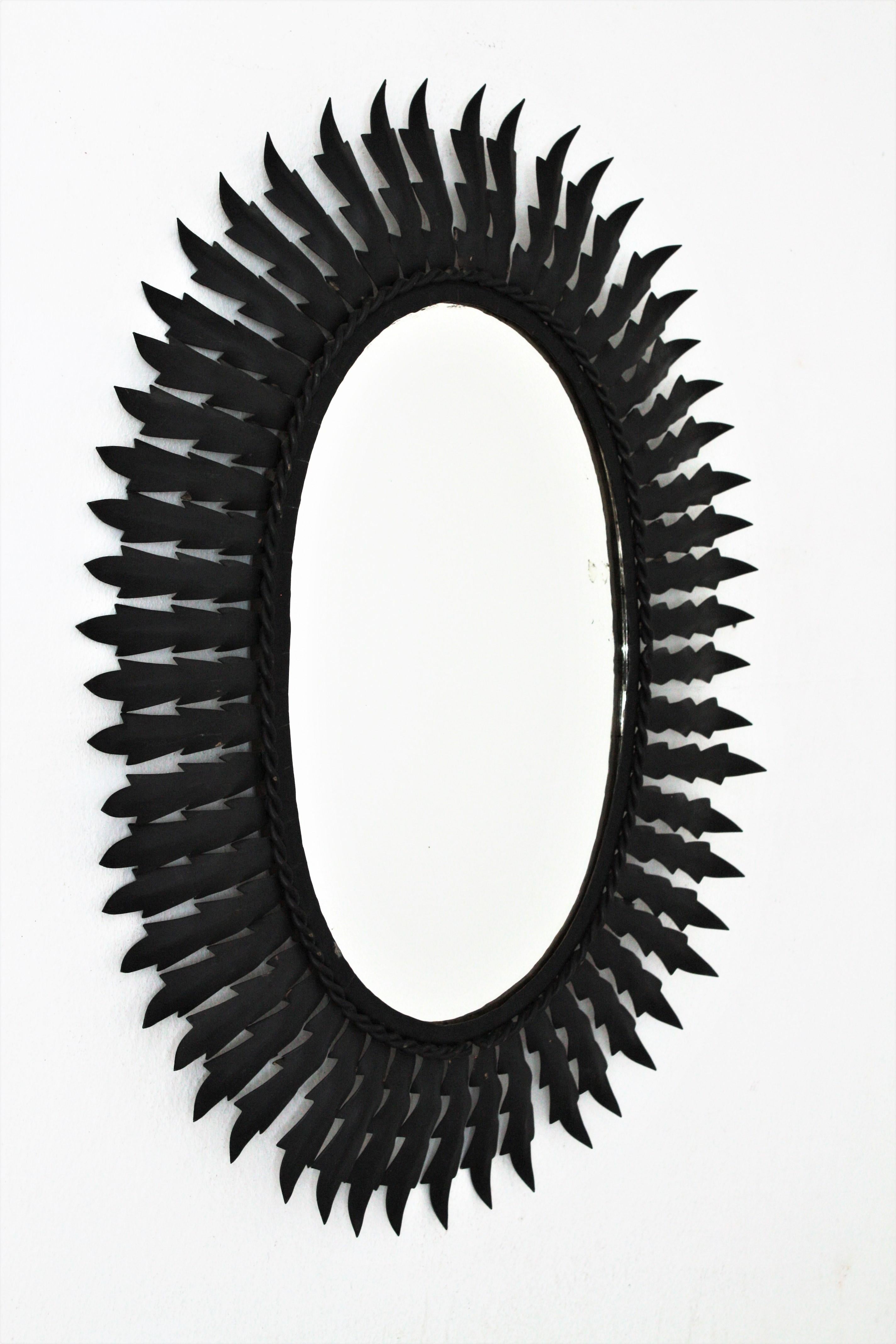 Mid-Century Modern Spanish Metal Sunburst Oval Mirror Painted in Black, 1960s