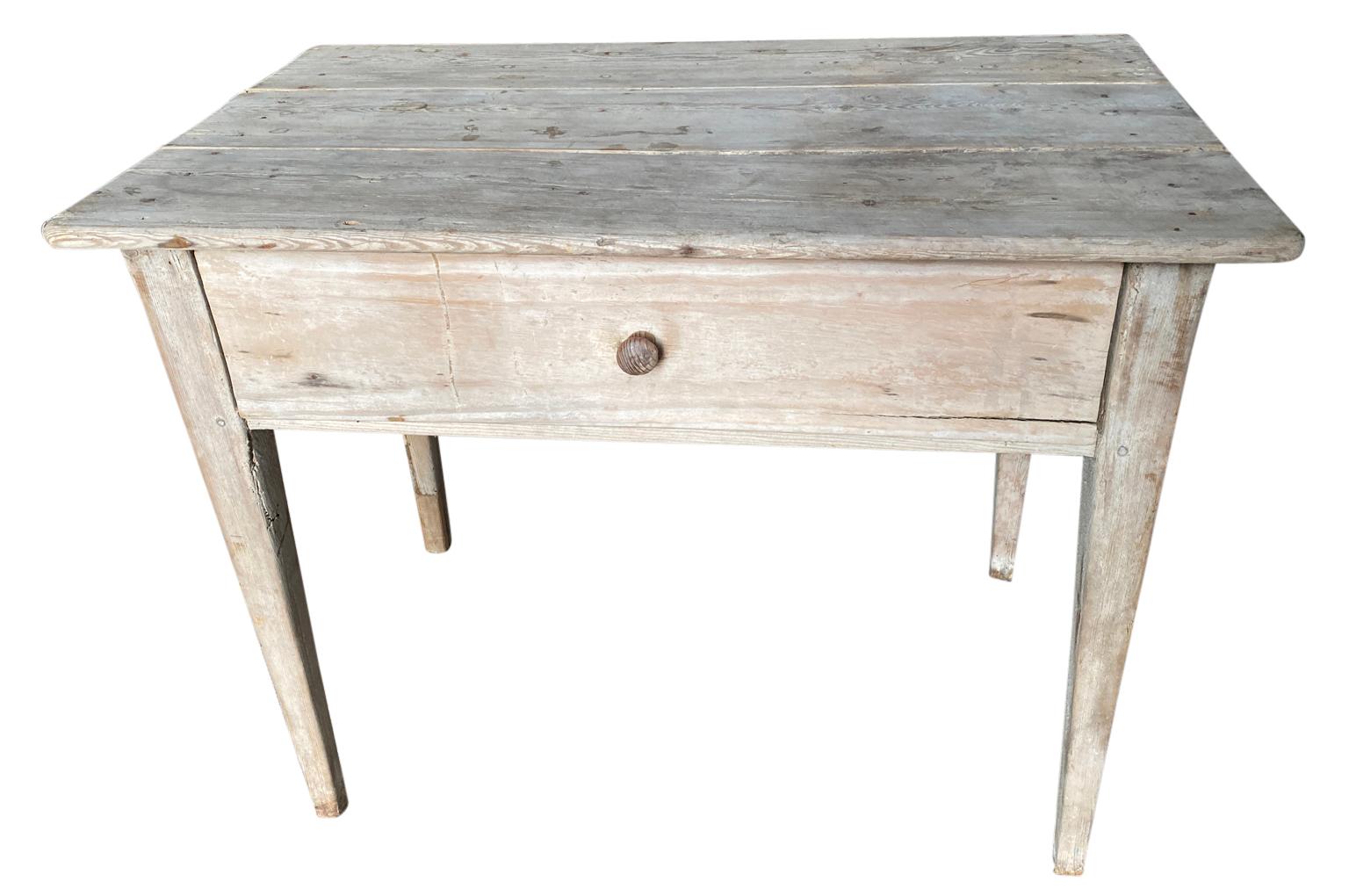 A very charming primitive mid-19th century console table - side table from the Catalan region of Spain. Soundly constructed from naturally washed pine with slightly tapered legs and a single door. Wonderful for any rustic or modern environment.