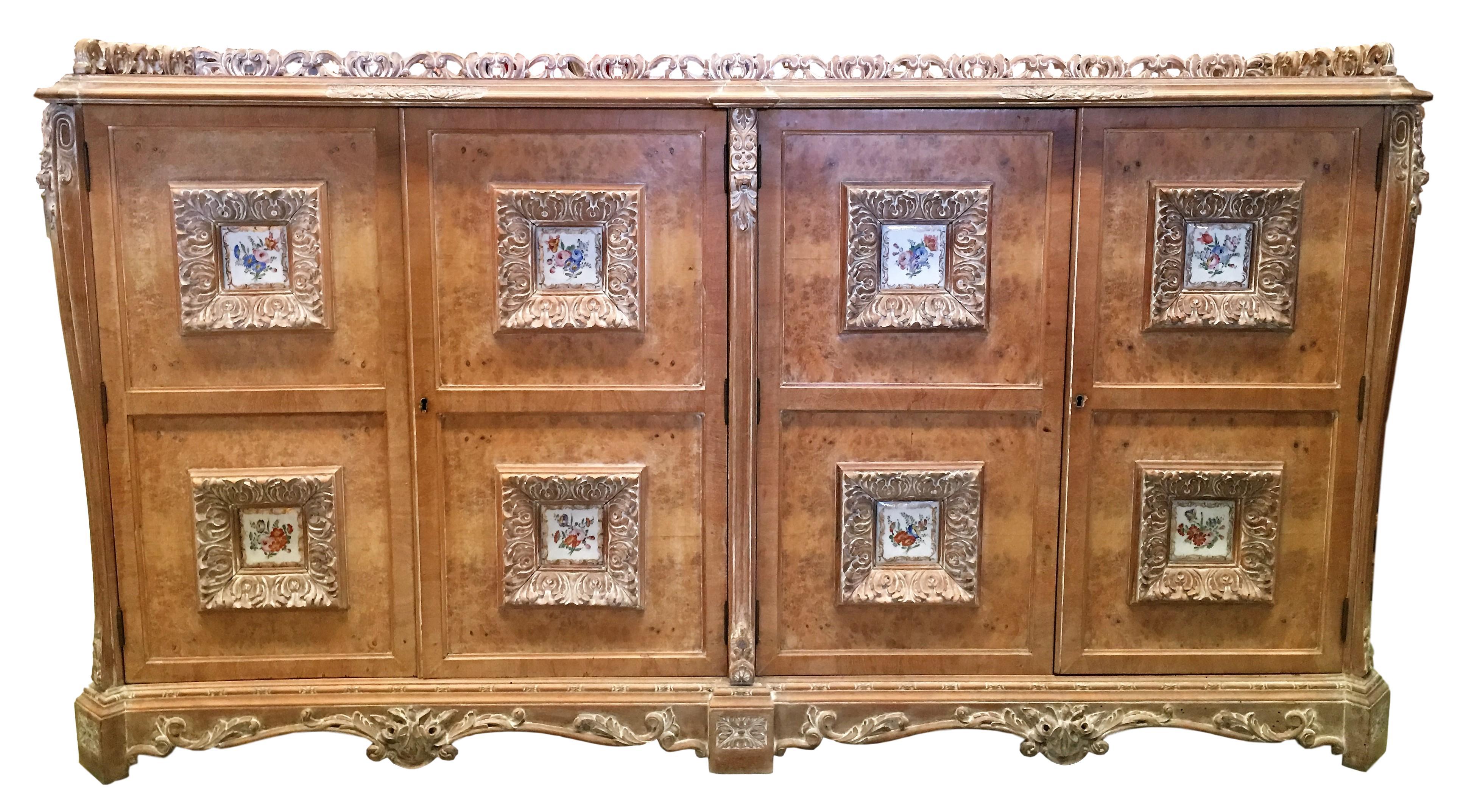 A large Spanish Mariano Garcia four door sideboard in light wood toned. Decorative painted ceramic panels on the doors. Two keys with working locks. A handsome piece with great proportions.
The interior it´s mirrored.
 