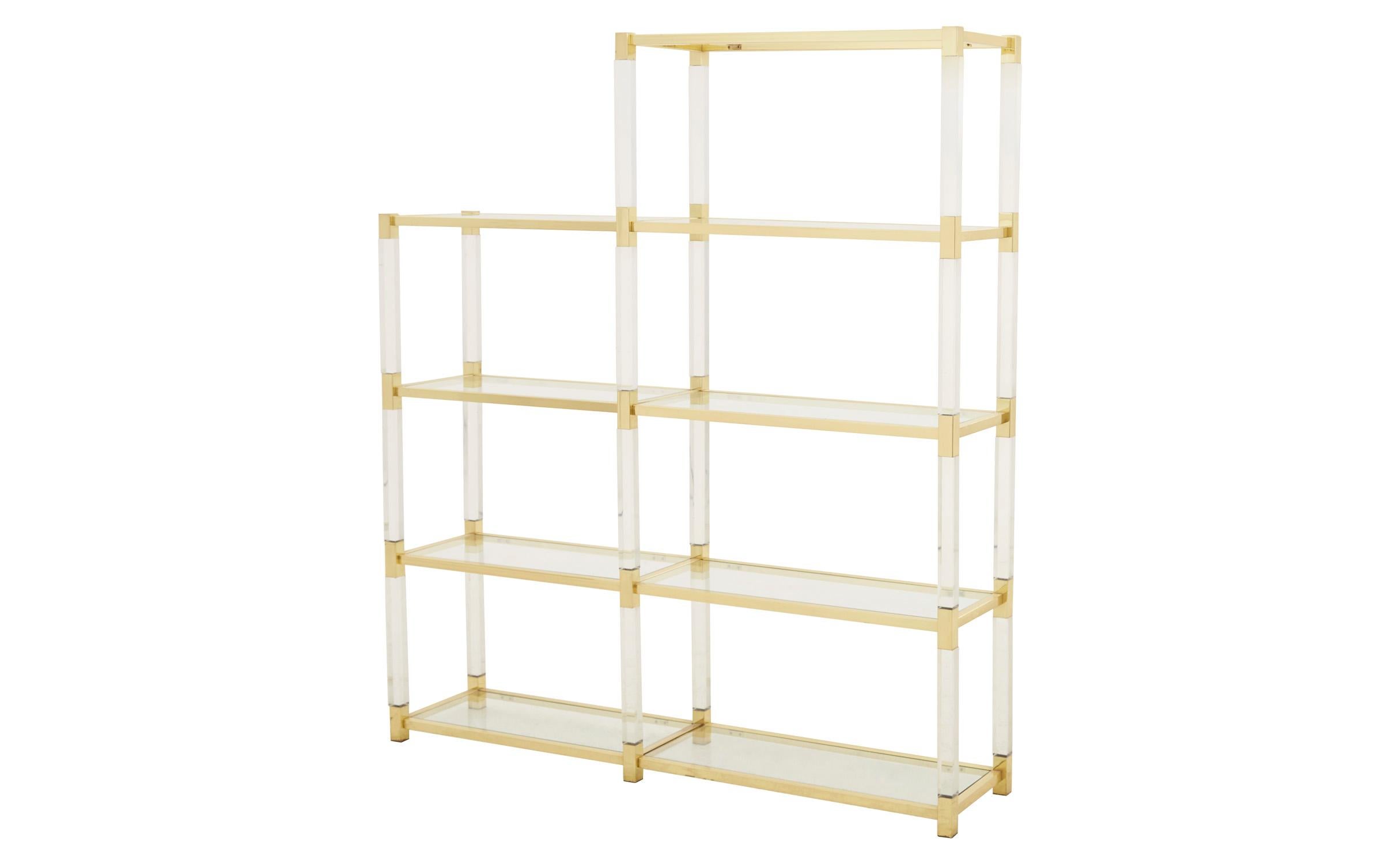 A relic of Hollywood Regency design, our Vintage Brass & Lucite Etagere was crafted in Spain in the mid-20th century. It features its original glass shelves, paired with a brass and lucite frame. This shelf is in excellent vintage condition, with