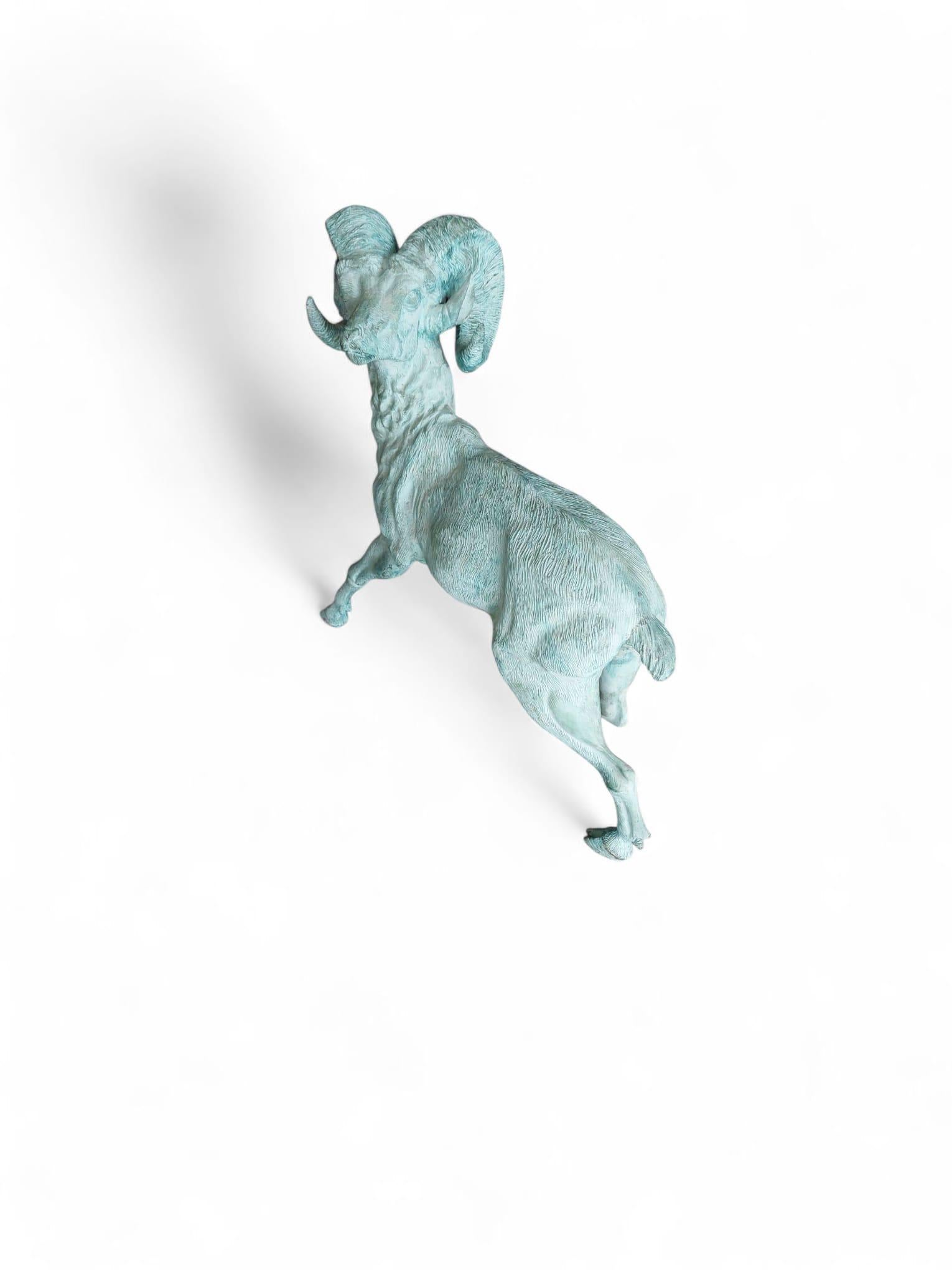 An impressive Spanish bronze sculpture from the 1950s, depicting a powerful ram in motion. Executed with remarkable detail, the piece captures the animal’s dynamic stance and the textured realism of its coat and curved horns. The naturalistic