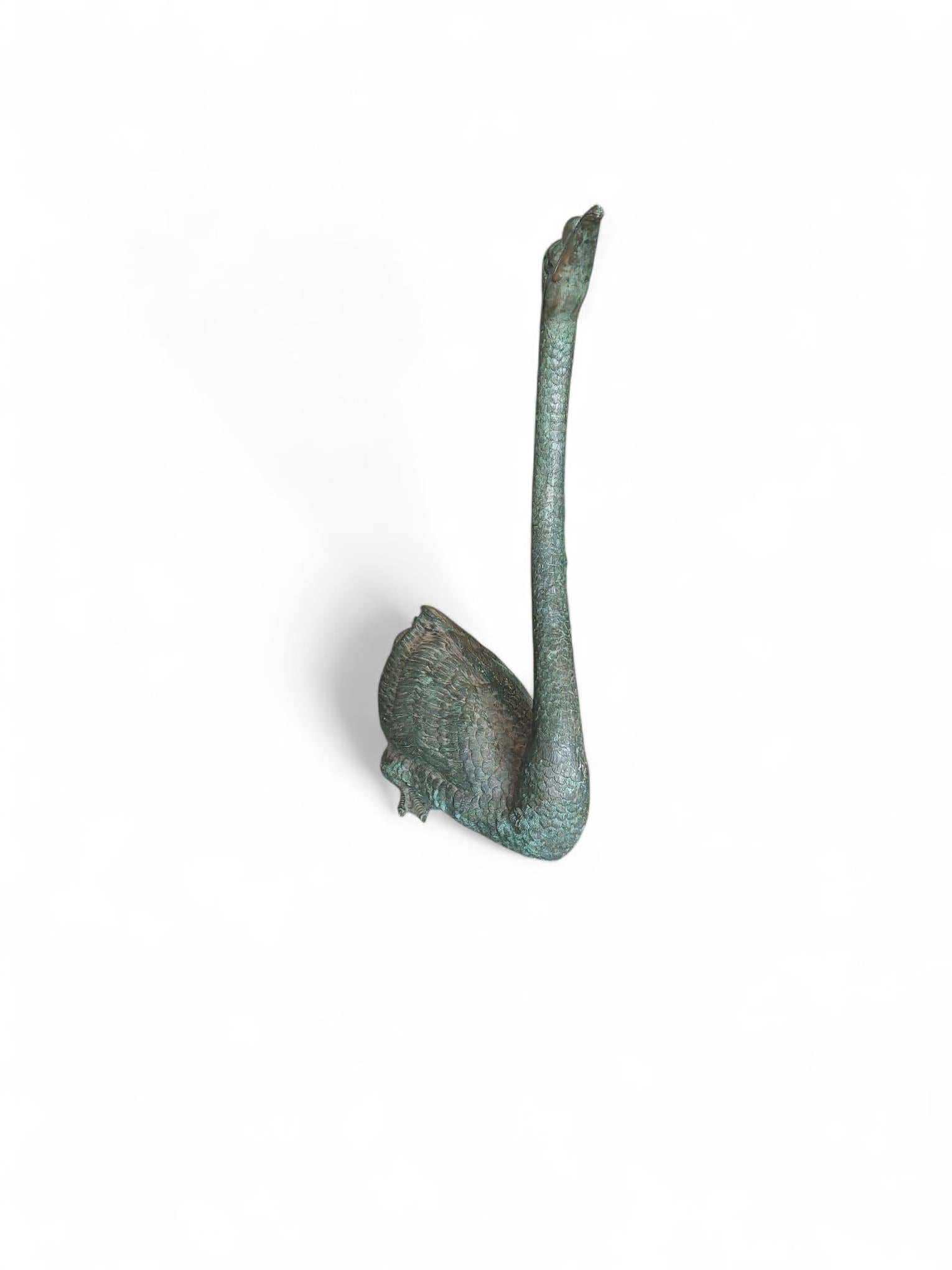 A graceful Spanish bronze sculpture from the 1950s, depicting a swan with elegant poise and naturalistic detail. The artist captured the bird’s long, arched neck, delicately modeled feathers, and serene expression, highlighting both the beauty and