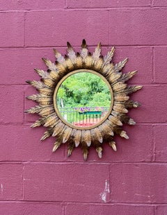 Specchio a raggiera in metallo dorato della metà del secolo scorso