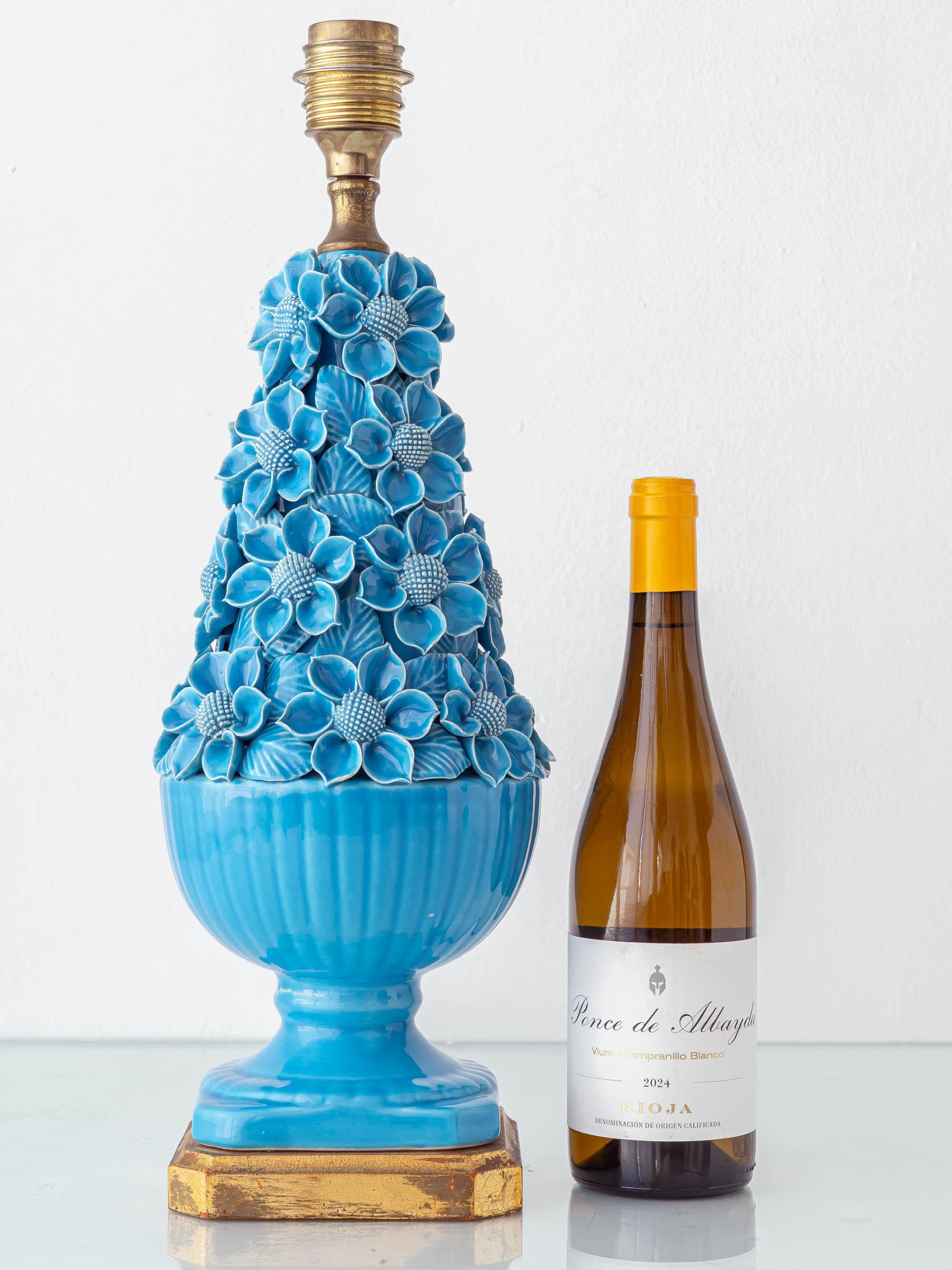 Meticulously hand-crafted in Spain in the 1960s and attributed to Cerámicas Bondia of Manises, this lamp exemplifies the exuberant artistry of Valencian ceramics. The form is richly adorned with hand-applied blossoms in vibrant turquoise glaze, each