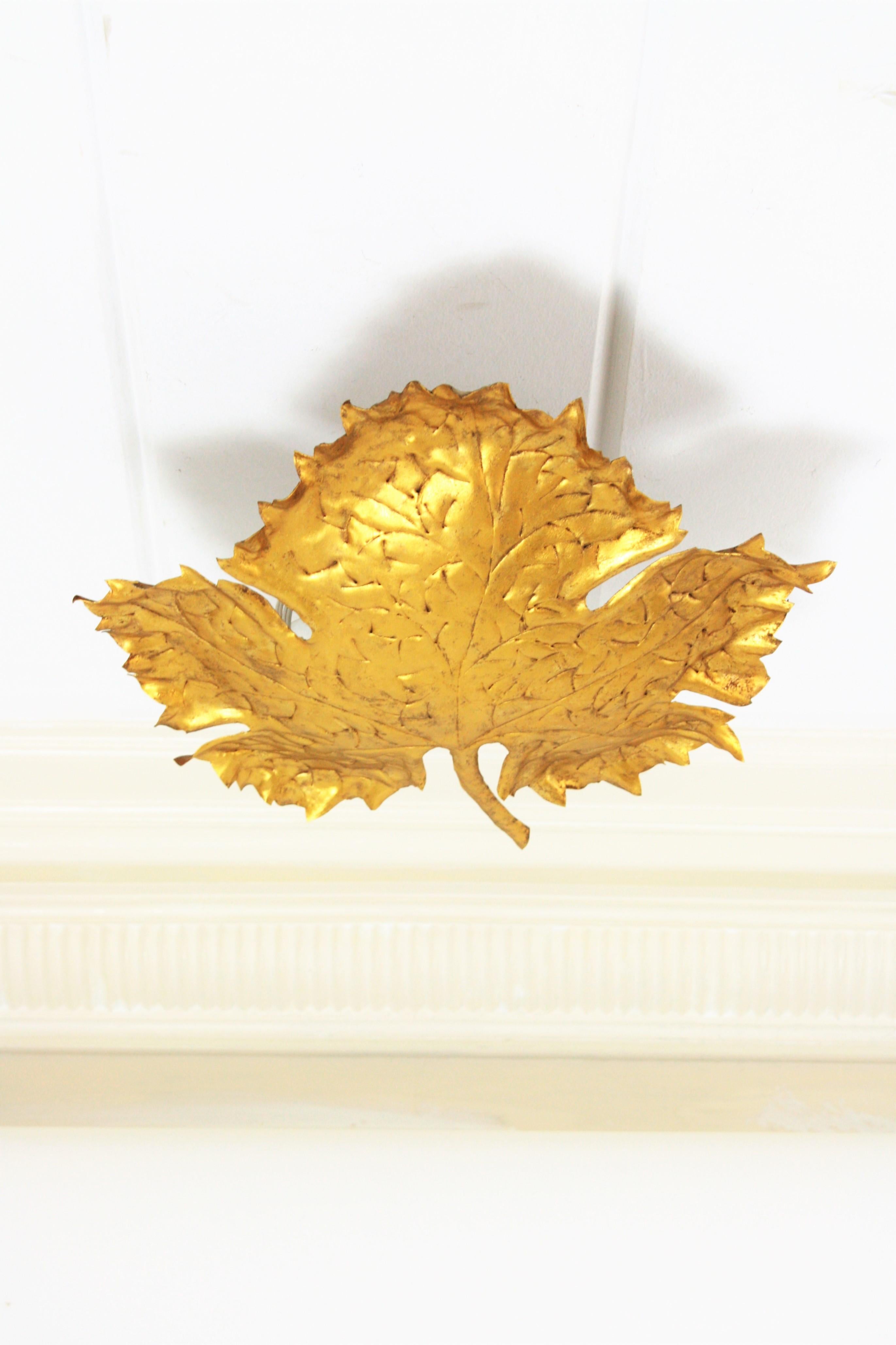 Unusual handcrafted iron plane tree leaf (platanus x hispanica) wall or ceiling light manufactured in Spain at the mid-20th century period with Brutalist design. This light fixture was richly hand-hammered made and it is full of detailed
