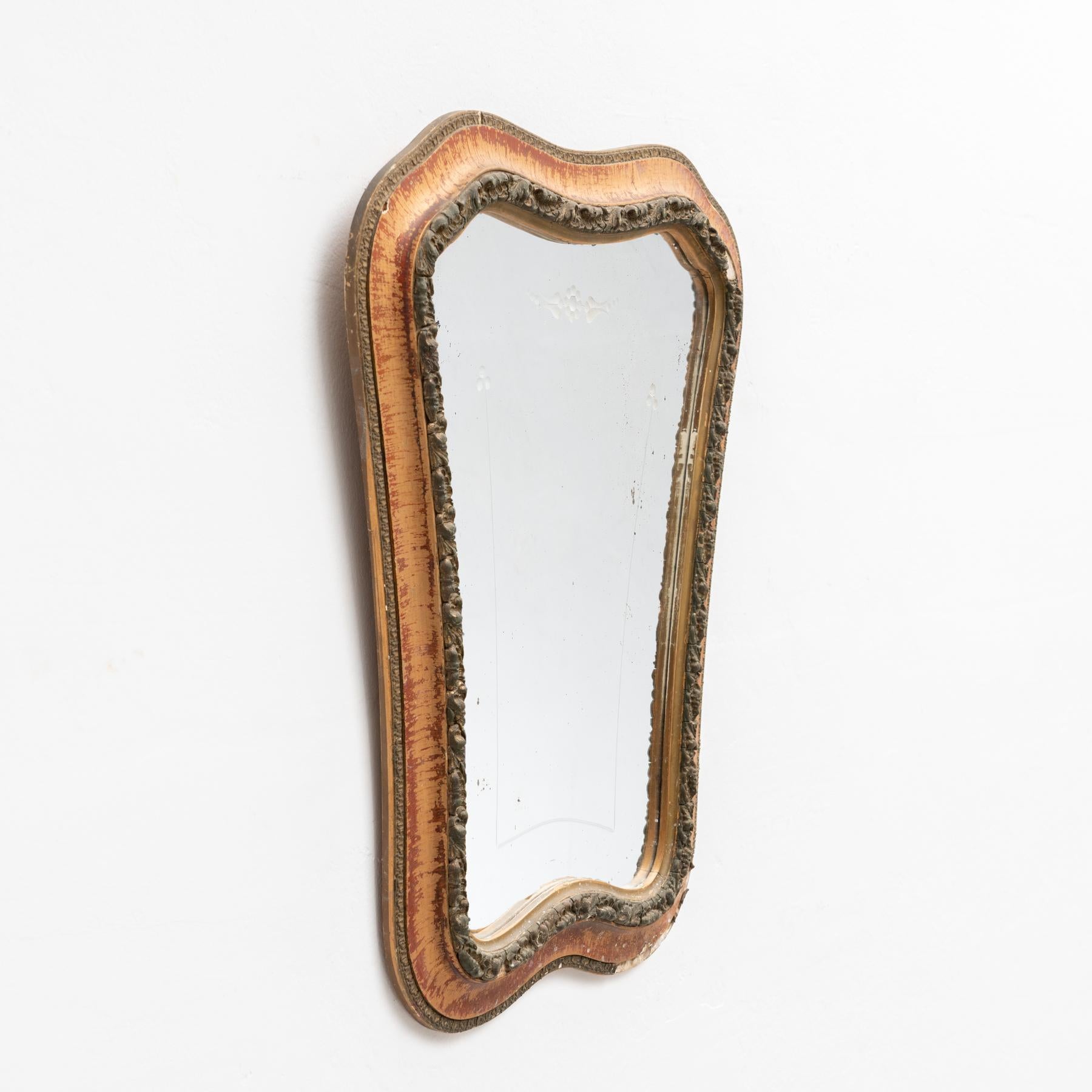 Handcrafted mid-century wood mirror made in Spain, circa 1950.

Add a touch of vintage elegance to your home with this handcrafted mid-century wood mirror, made in Spain circa 1950. This beautifully crafted piece showcases the warmth and charm of