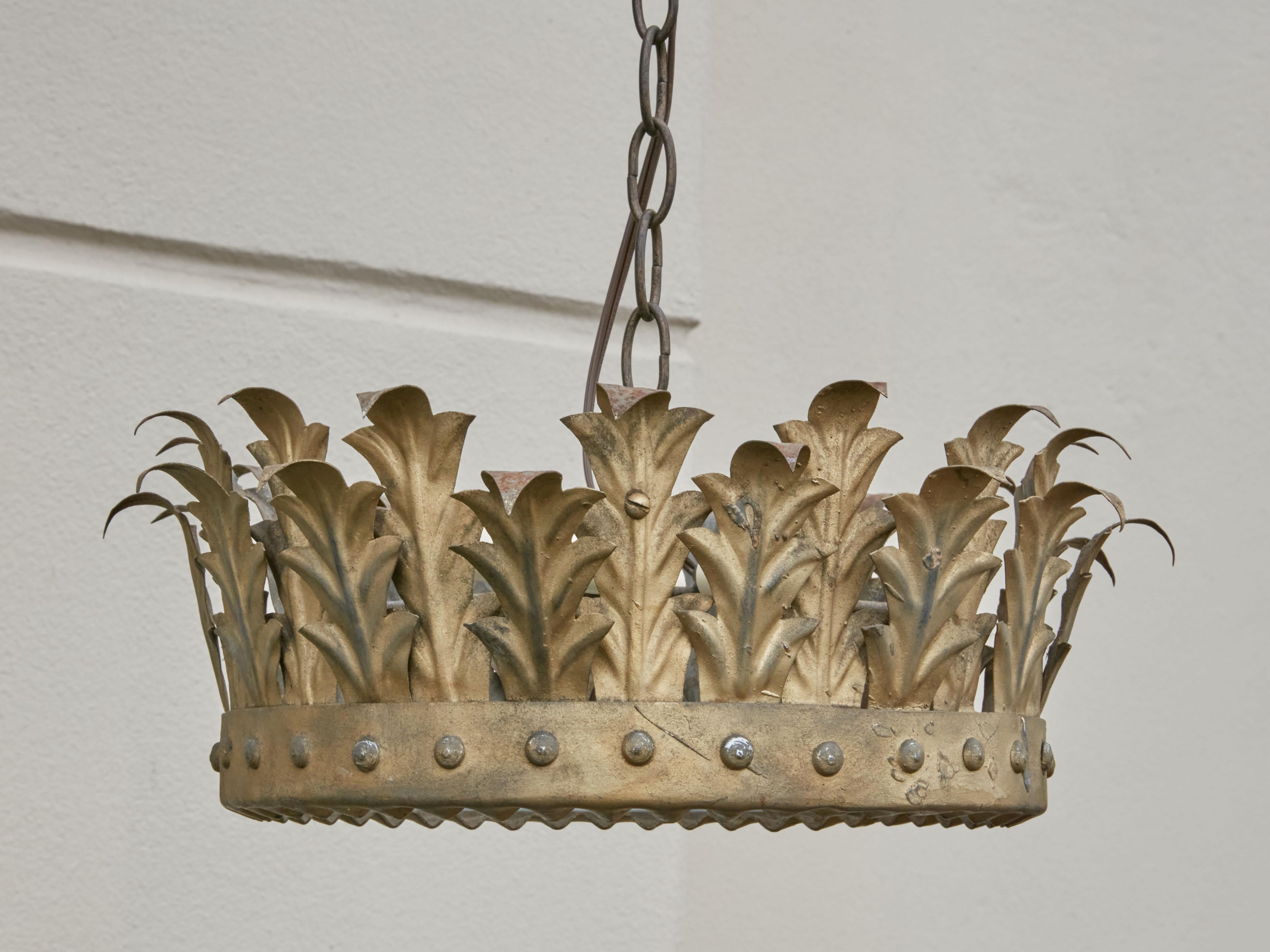 A Spanish vintage gilt metal three-bulb semi-flush crown light fixture from the mid-20th century, with frosted glass and new wiring. Created in Spain during the midcentury period, this crown chandelier features a decor of curving gilt metal foliage,