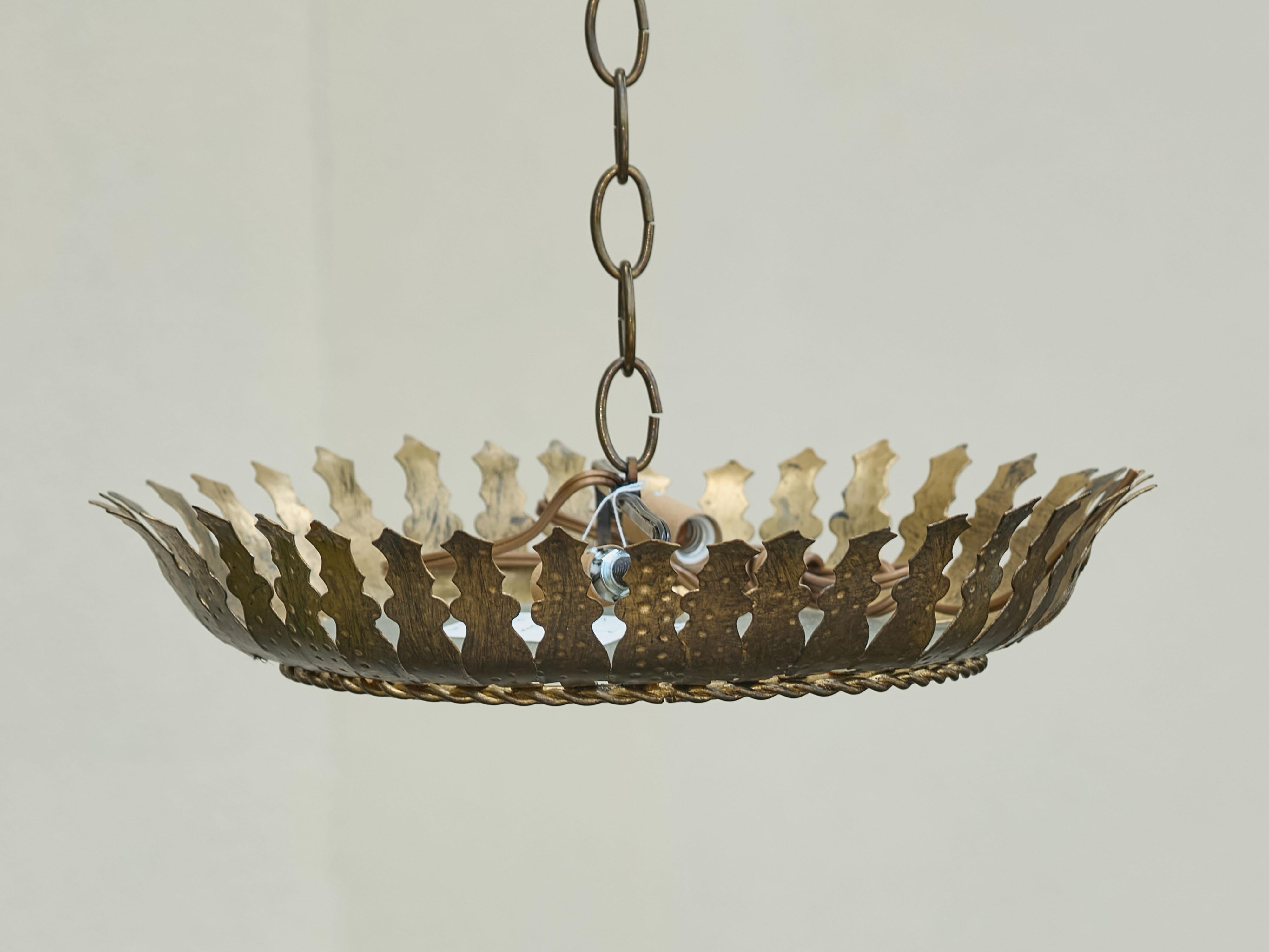 A Spanish vintage gilt metal two-bulb semi-flush crown light fixture from the mid-20th century, with stylized foliage motifs, frosted glass and new wiring. This Spanish vintage gilt metal semi-flush crown light fixture from the mid-20th century