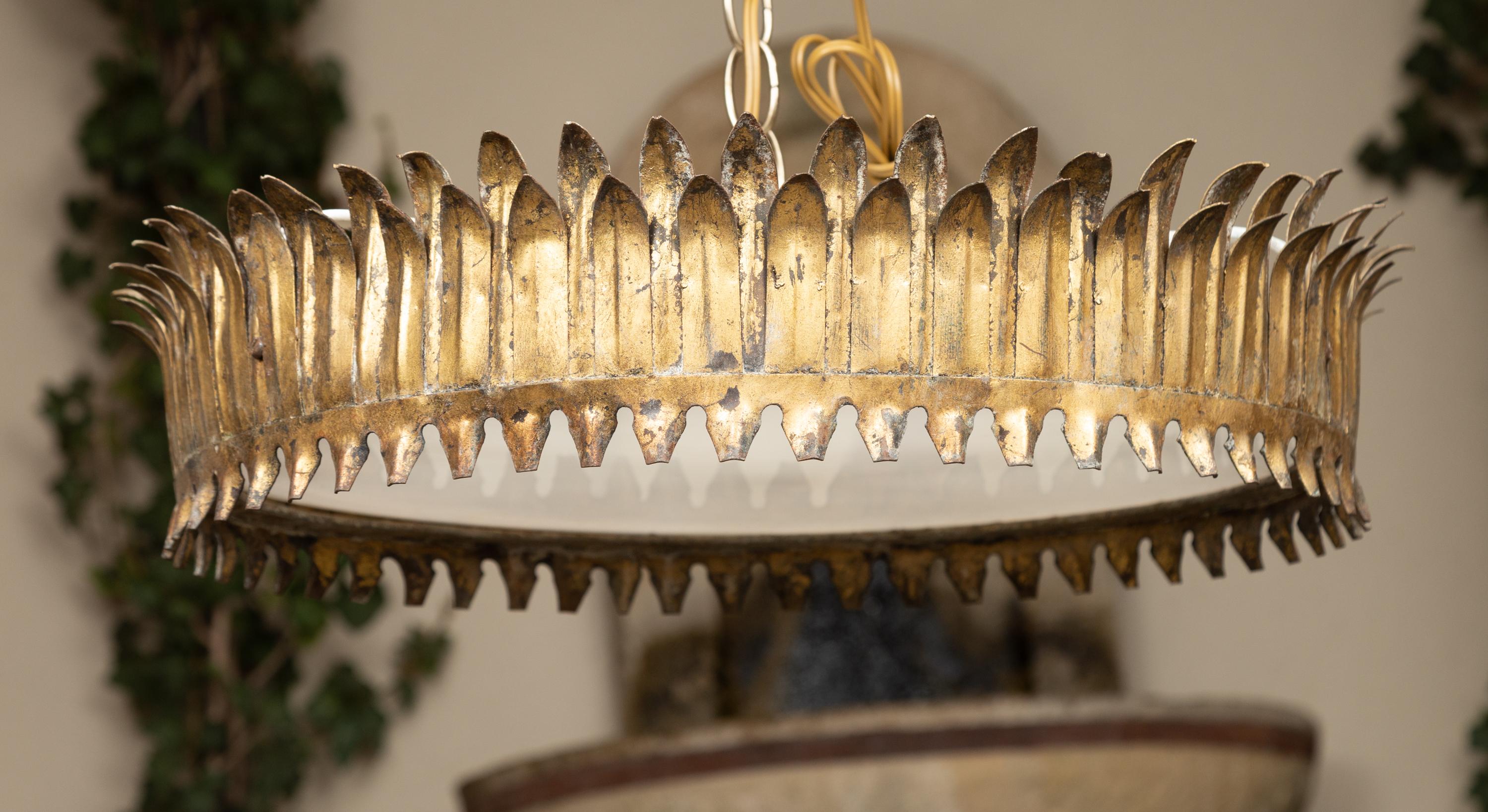 A Spanish vintage gilt metal three-bulb crown chandelier from the mid-20th century, with leaf motifs, frosted glass and new wiring. Created in Spain during the midcentury period, this vintage Spanish gilt metal semi-flush crown chandelier is adorned