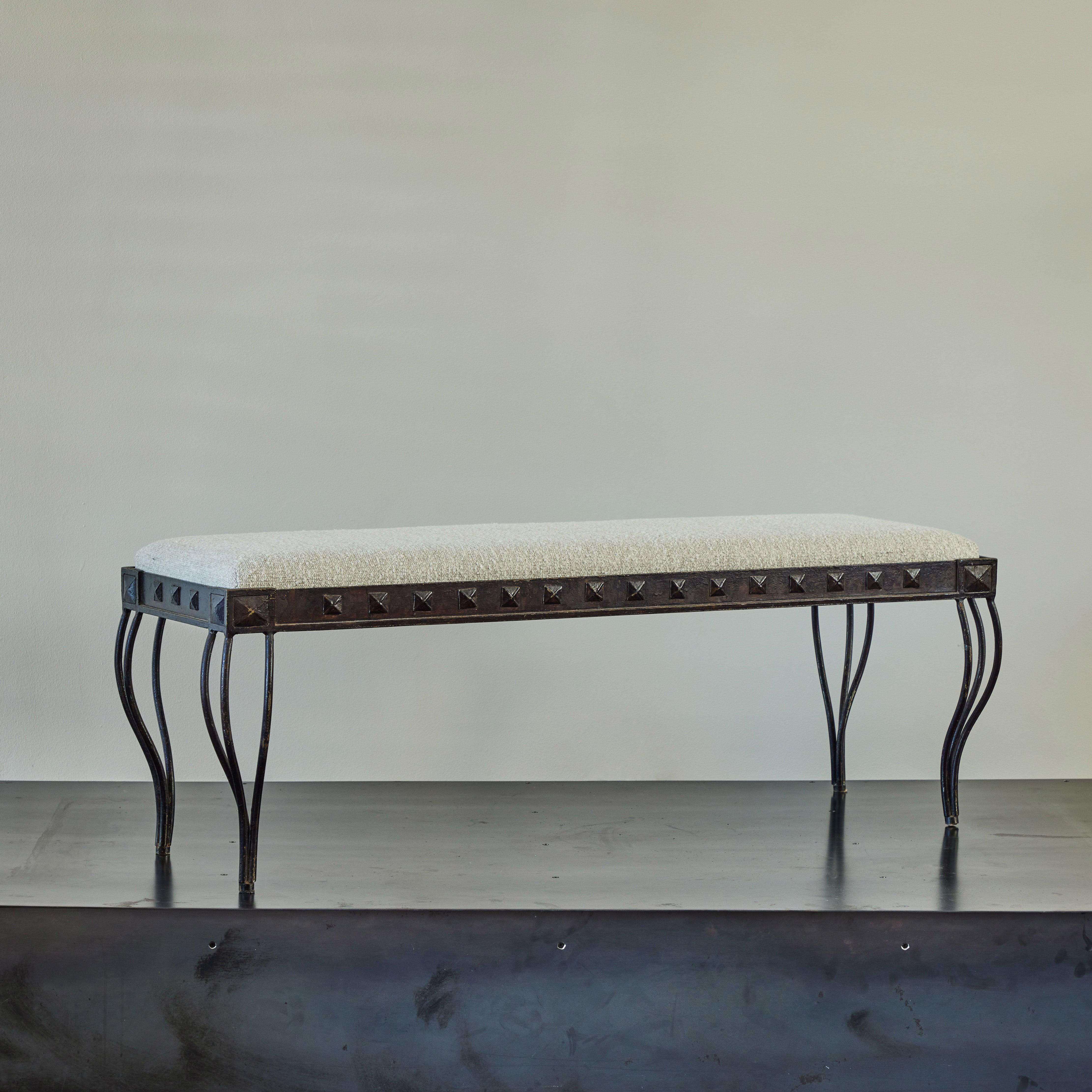 Upholstered Spanish midcentury cast iron bench. A chic artisanal piece that would work particularly well in an entrance space, living space, or bedroom. Featuring Minimalist three-wired legs in a slender, tapered neoclassical shape, the bench is