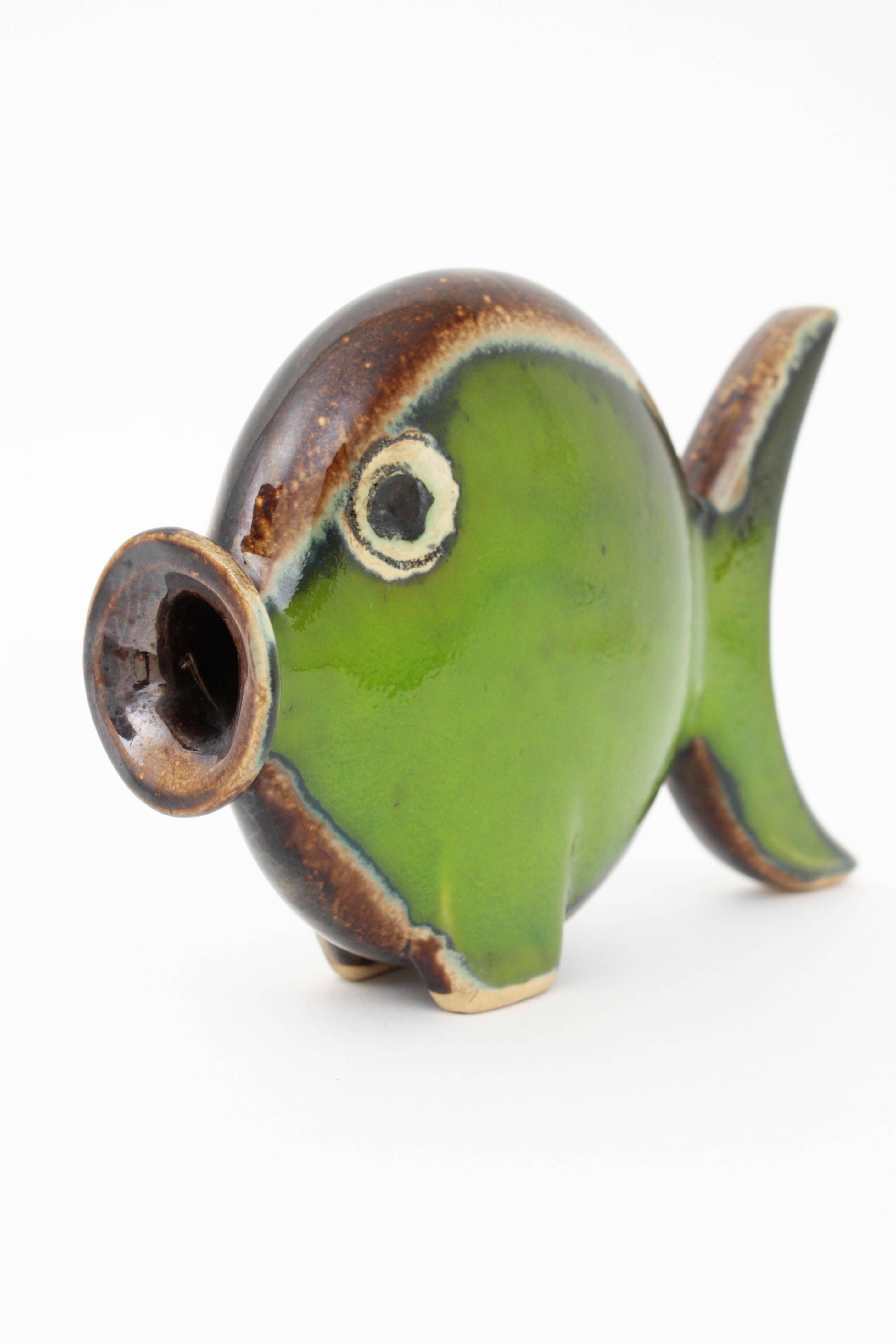 Eye-catching fish figurine made in glazed ceramic in green, white and brown colors, Spain, 1950s.
Beautiful to place with other ceramic pieces creating a set with other ceramic pieces.
Perfect as a gift idea
Measures: 17 cm W x 12 cm H x 5 cm
