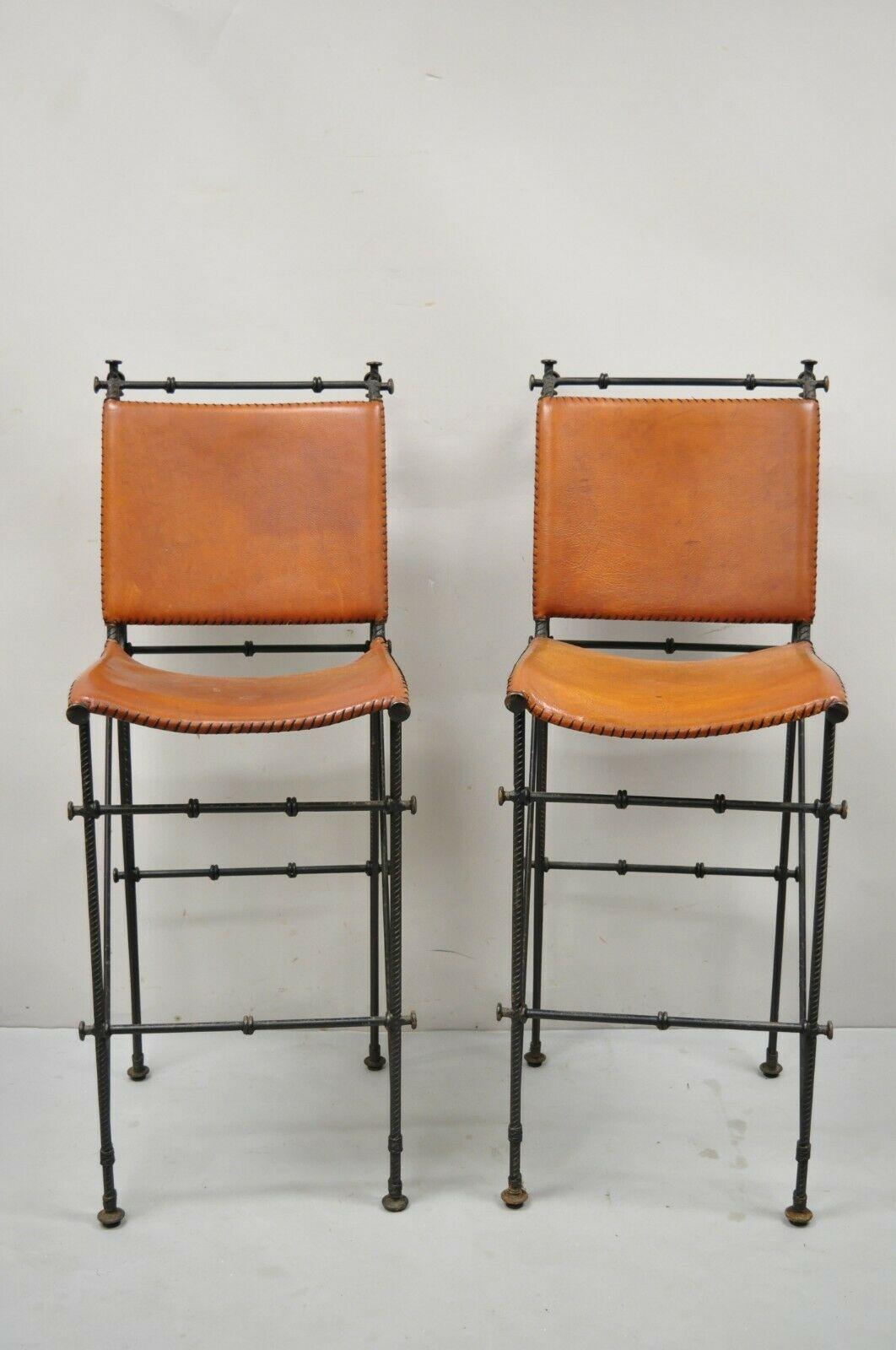 Spanish Modern Orange Burnished Leather Wrought Iron Bar Stools after Ilana Goor - a Pair. Set features orange burnished high quality leather backs and seats, heavy wrought iron frames, rustic finish, hand stitched details, quality craftsmanship,