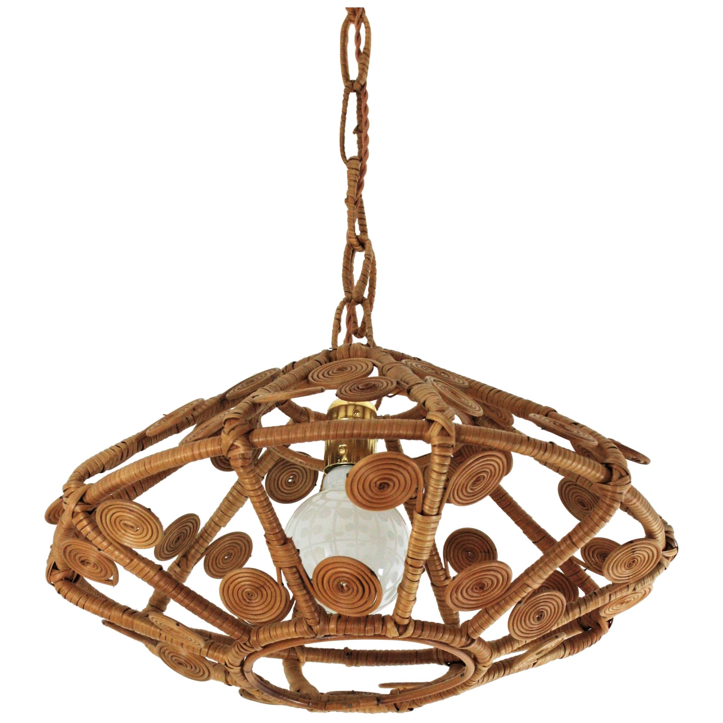 Eye-catching handcrafted wicker / rattan suspension lamp or lantern with artistic filigree work. Spain, 1960s
This rattan pendant features a lampshade structure all made in cane with beautiful scroll and filigree motifs and reminiscences in design