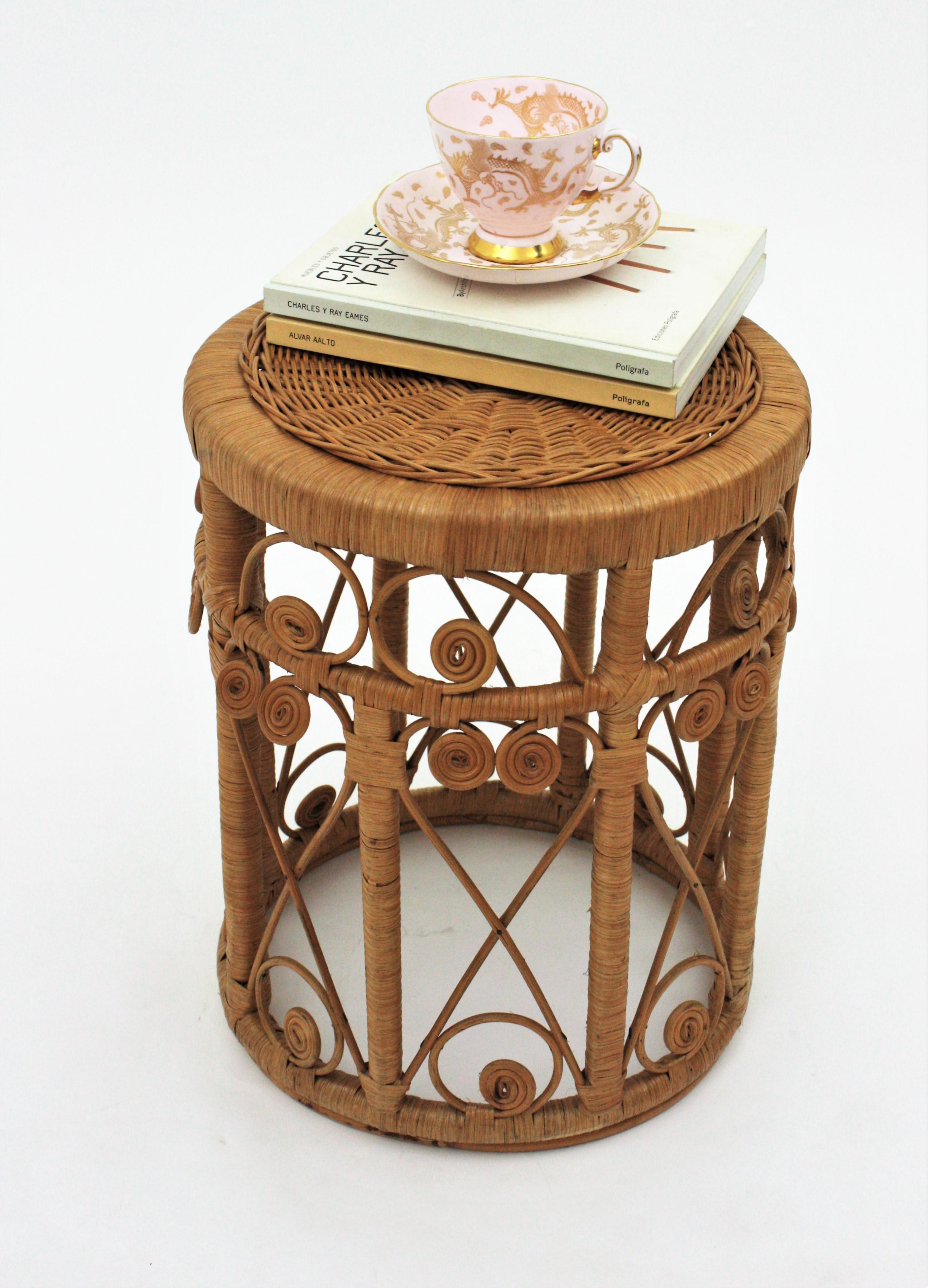 Lovely handcrafted wicker cane stool, side table or stand with beautiful artistic filigree work. Spain, 1960s
This round stool has all the taste of the Mediterranean Midcentury and Bohemian style and reminiscences in design of the peacock