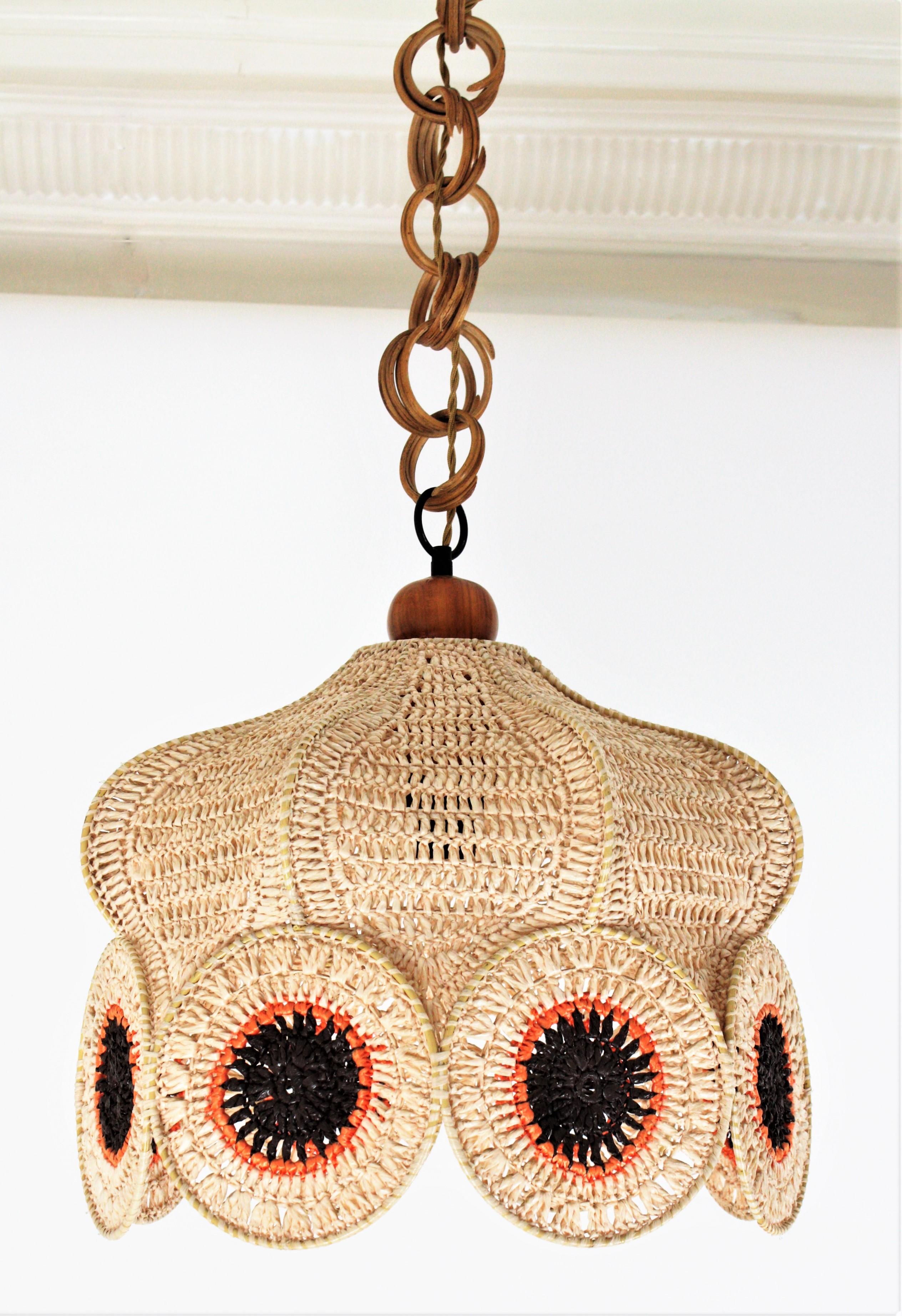 A funny Bohemian hand knotted macramé suspension lamp with colorful circles accenting the bottom. Spain, 1960s-1970s.
This handcrafted chandelier features a shade made of hand knotted macrame acrylic cord. The top of the shade is adorned by a wooden