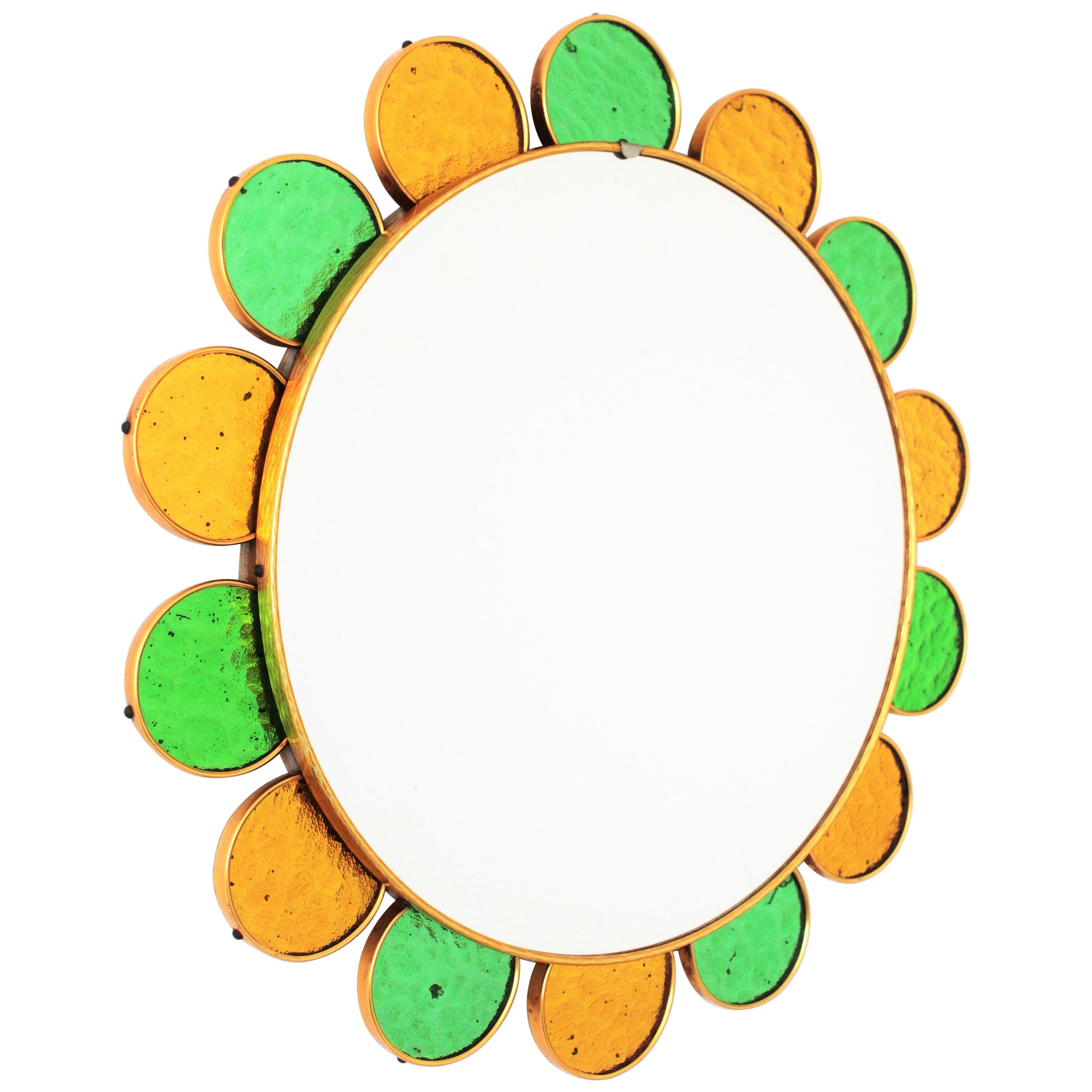 Eye-catching Mid-Century Modern flower shapes mirror with gilt and green textured glass frame. Spain, 1960s
This wall mirror features a frame comprised by alternating glass petals in two colors. Surrounding the glass petals and the central glass