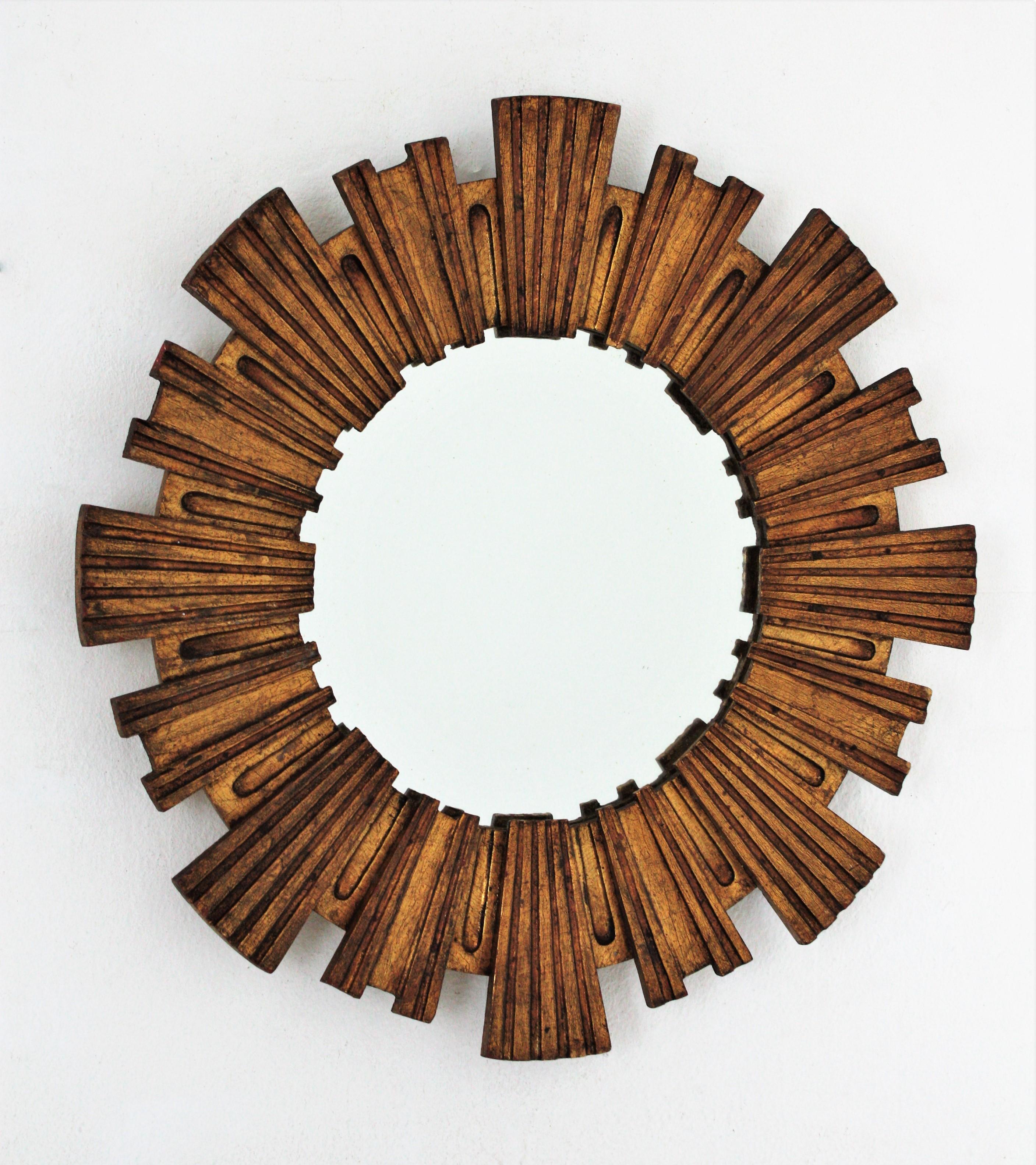 Gorgeous hand carved gold leaf giltwood sunburst mirror by Francisco Hurtado. Spain, 1950s-1960s.
This sunburst mirror manufactured at the Mid-Century Modern period combines accents of Baroque style with midcentury style. It would be a nice
