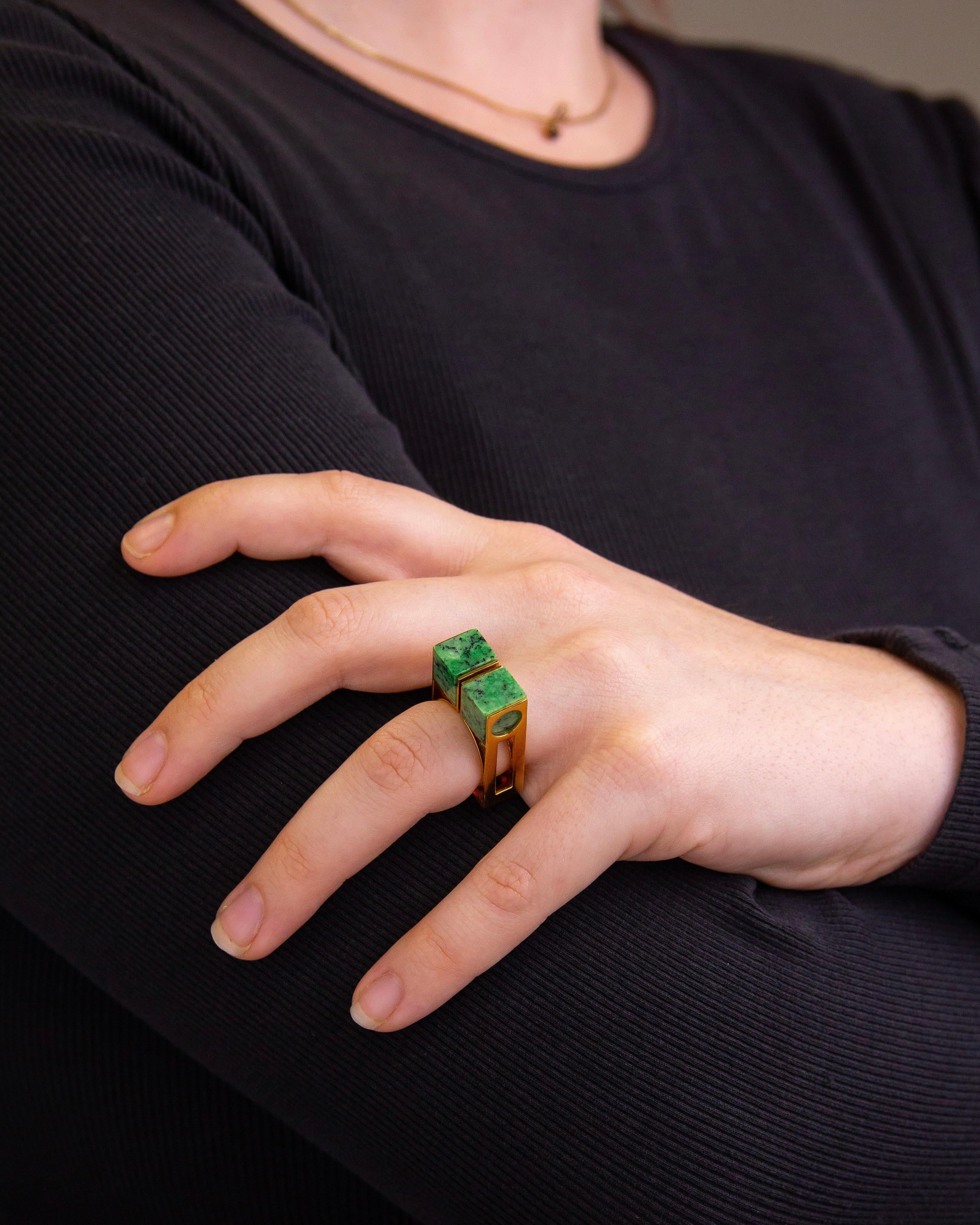 Crafted from 18 karat yellow gold and set with green grossular garnet, this unusual ring is undeniably modernist in its design. The ring which has marks indicating it was manufactured in Spain is likely to have been manufactured in the 1970s,