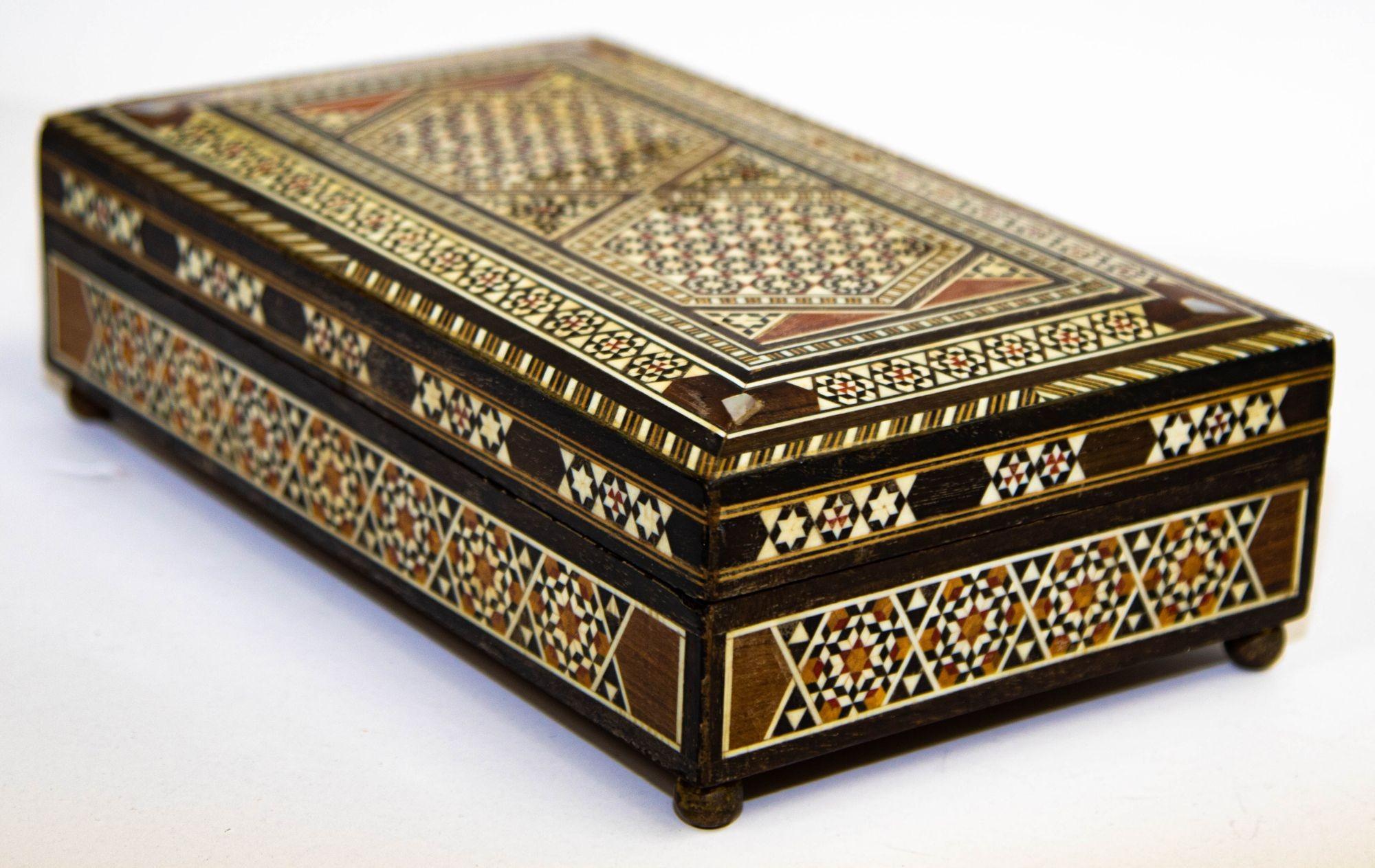 Spanish Inlaid Marquetry Jewelry Music Box.
Spanish inlaid Marquetry music box, cigarette box. Handcrafted in Spain in the Moorish Syrian style. Finely inlaid in Islamic Moorish geometric designs with ebony and bone and other precious wood. When you