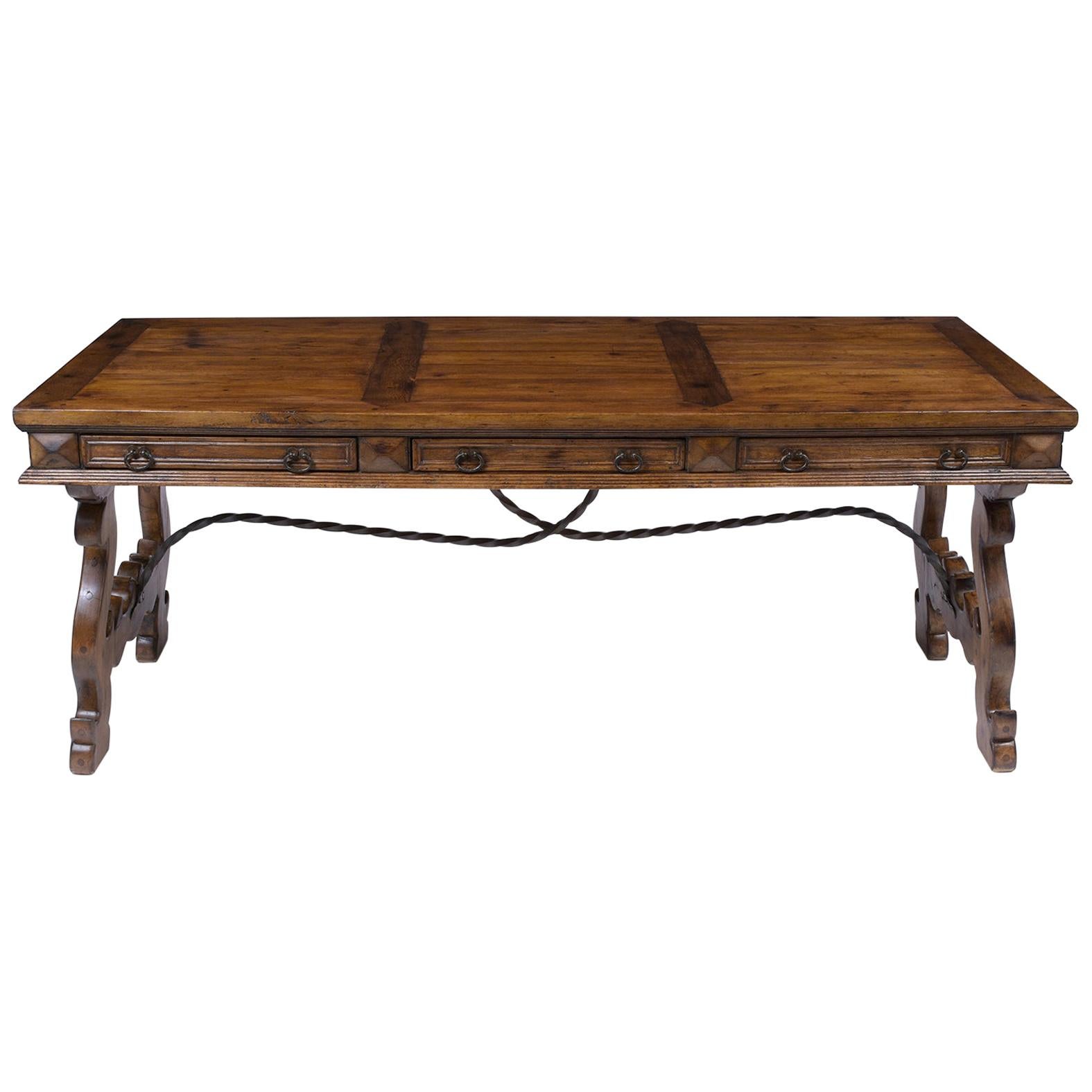 An extraordinary vintage Spanish colonial dining table is hand-crafted out of solid oak wood and has been completely restored by our professional team of expert craftsmen. This beautiful dining room table features a rich dark walnut color stain, a