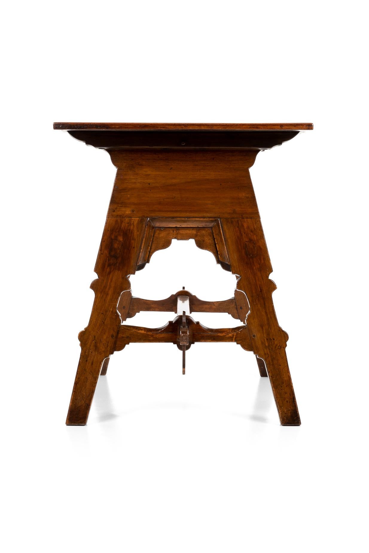 An unusual Spanish olive wood table with a rectangular top with intricately inlaid panels. The panels depict rampant lions in each corner with harlequin and classical motifs to the sides. Splayed trestle base and central shaped stretcher, with