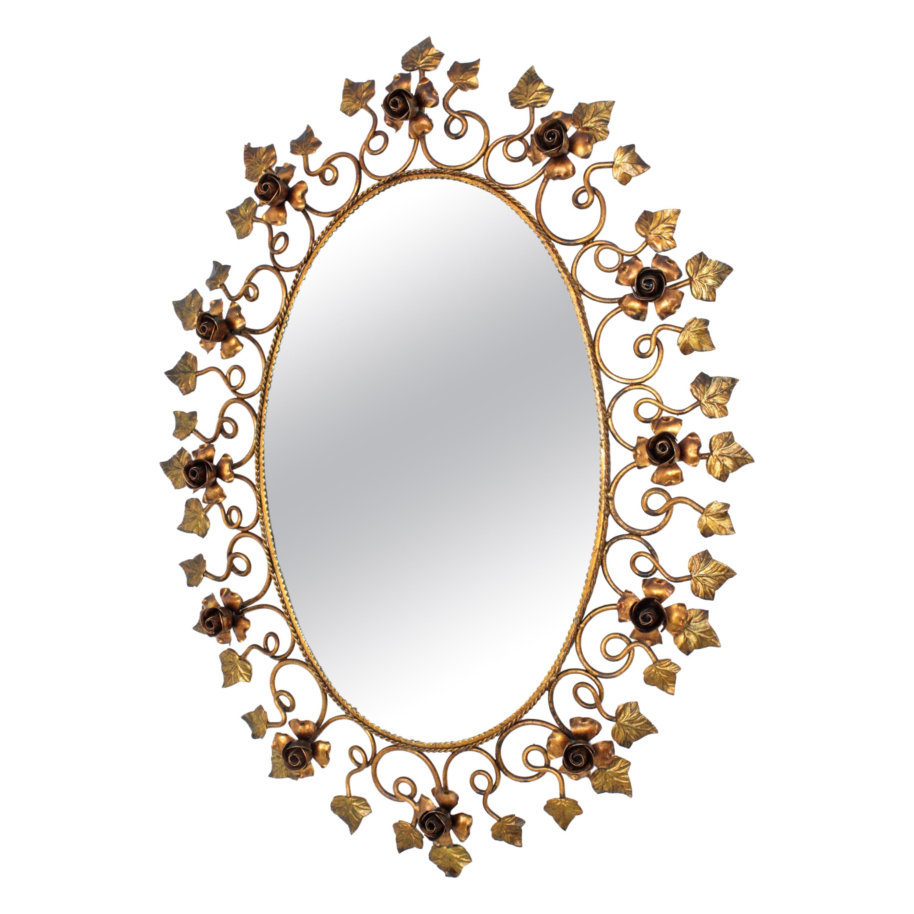 Hollywood Regency gilt iron oval mirror framed by a decoration of roses and leaves, Spain, 1950s.
This mirror has a finely handcrafted work and its detailed frame is highly decorative.
Ot will be a nice addition in a bathroom, dressing room or