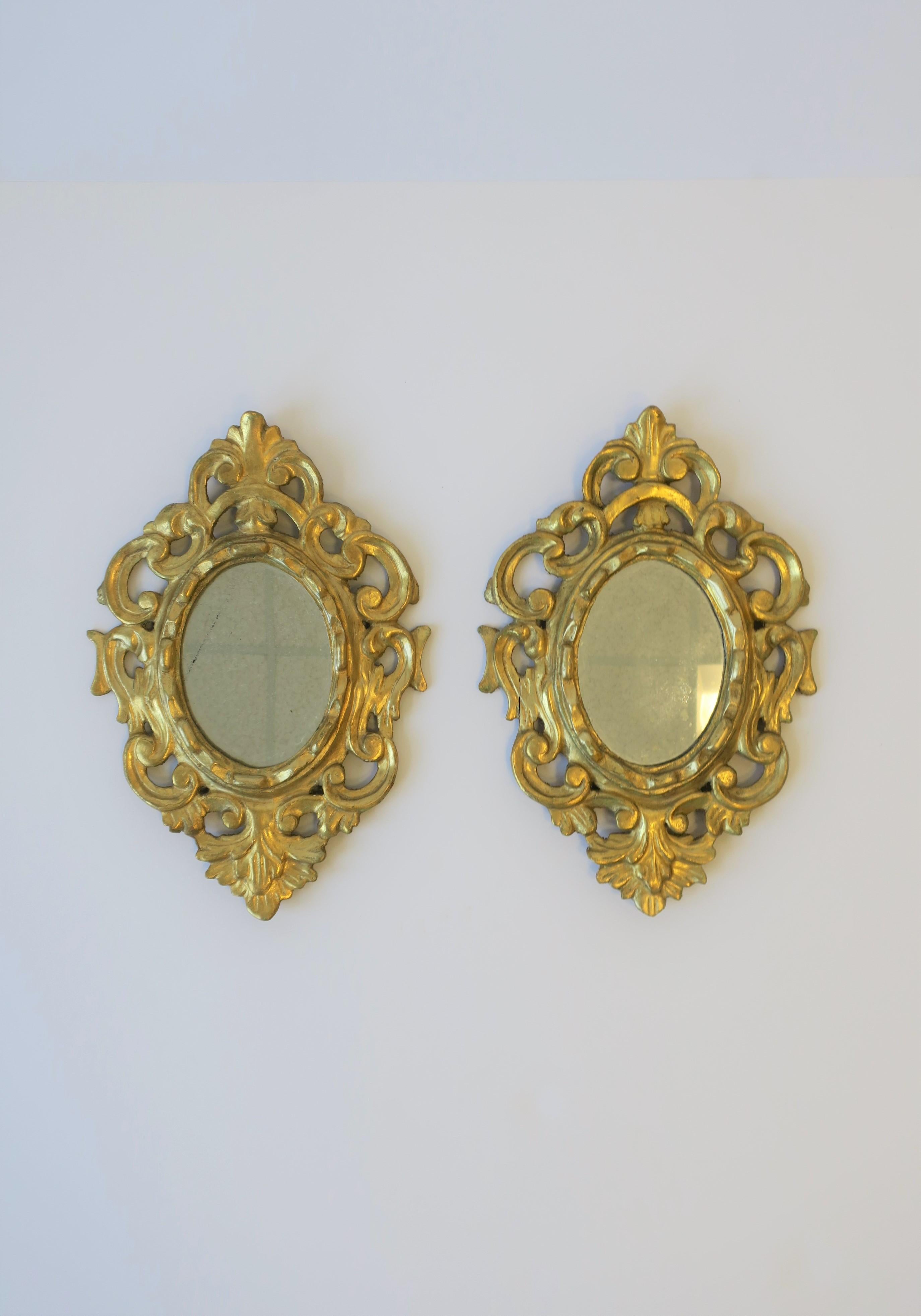A European oval gold giltwood wall mirror(s) from Spain, circa early to mid-20th century. Each mirror is marked on back 