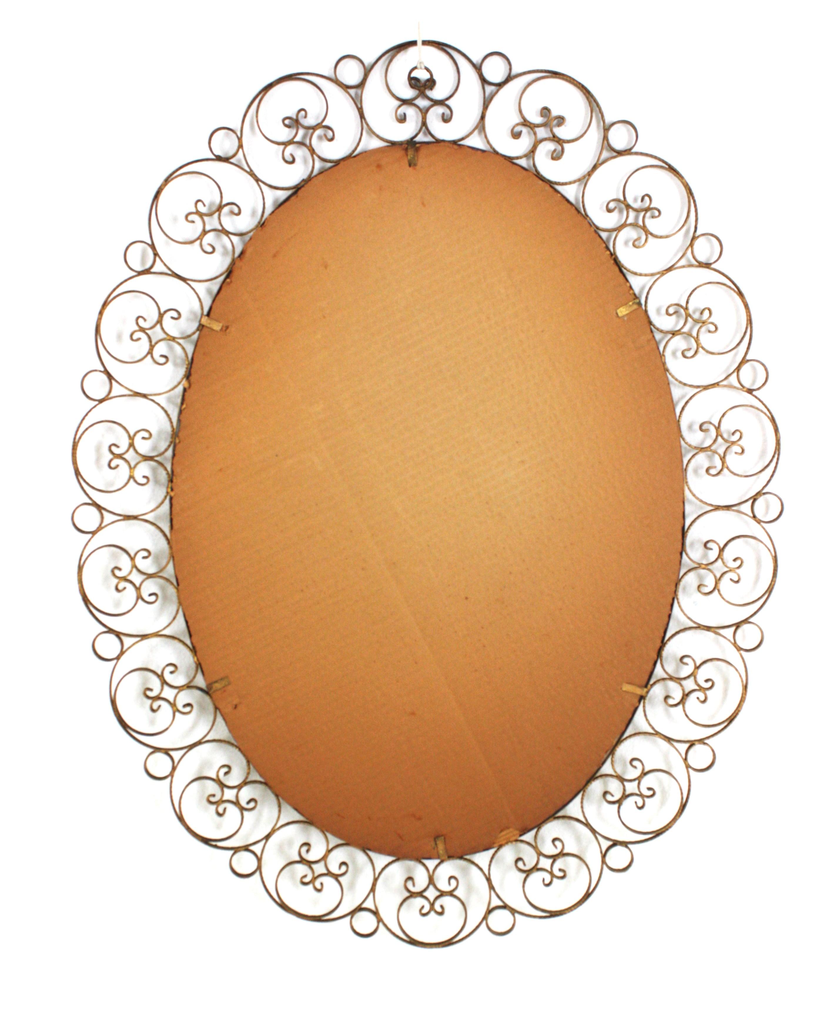 Spanish Oval Mirror in Gilt Iron with Scrollwork Frame For Sale 4