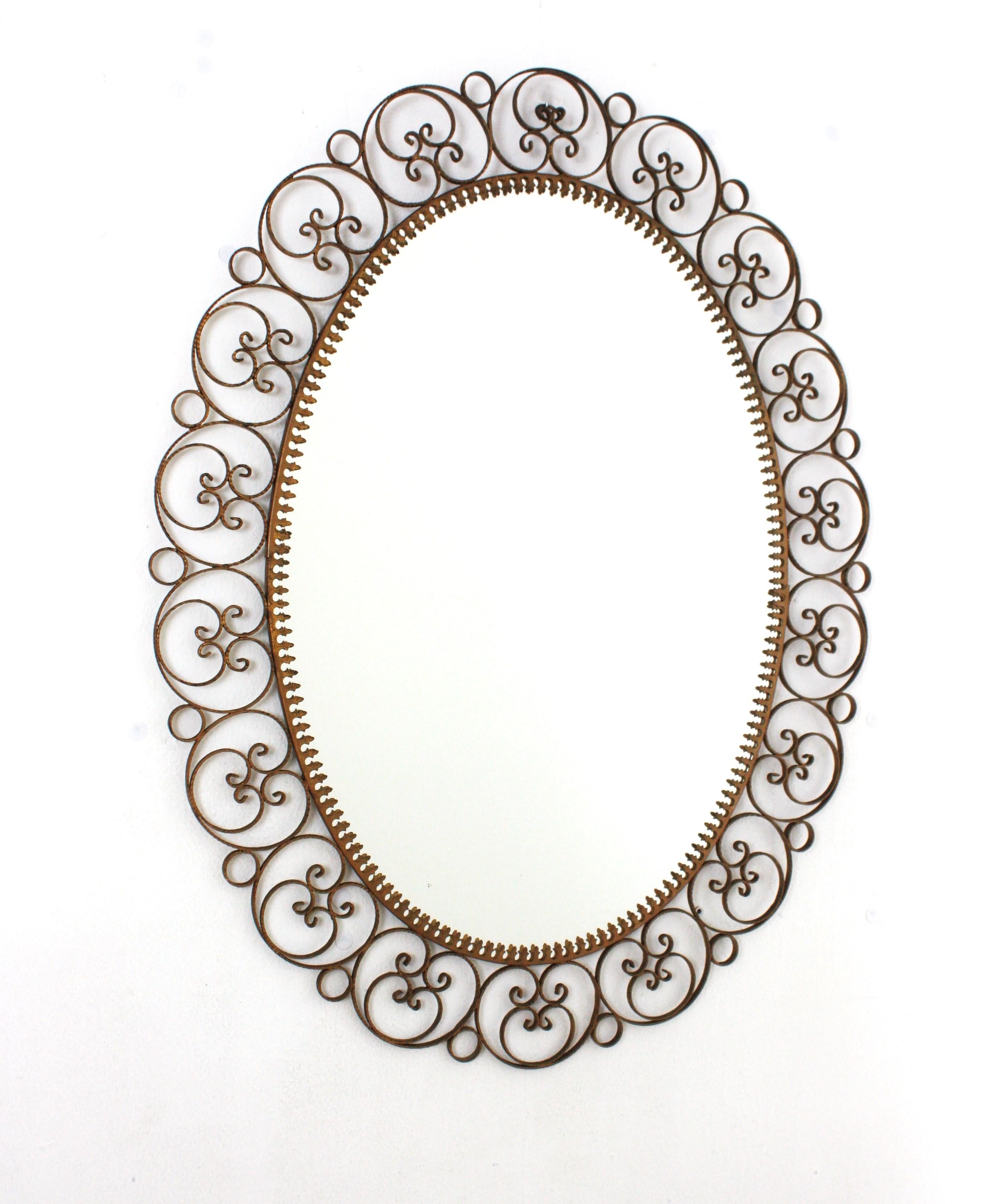 Mid-Century Modern Spanish Oval Mirror in Gilt Iron with Scrollwork Frame For Sale