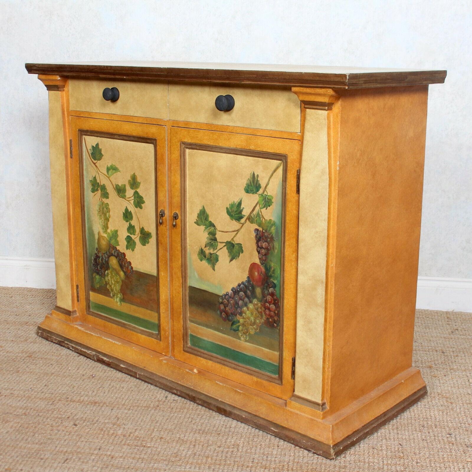 An impressive highly decorative Spanish painted and papered cabinet.
The rectangular projecting top above two frieze drawers and cupboard doors, painted with fruits and vines, enclosed painted interior and shelving and raised on a plinth