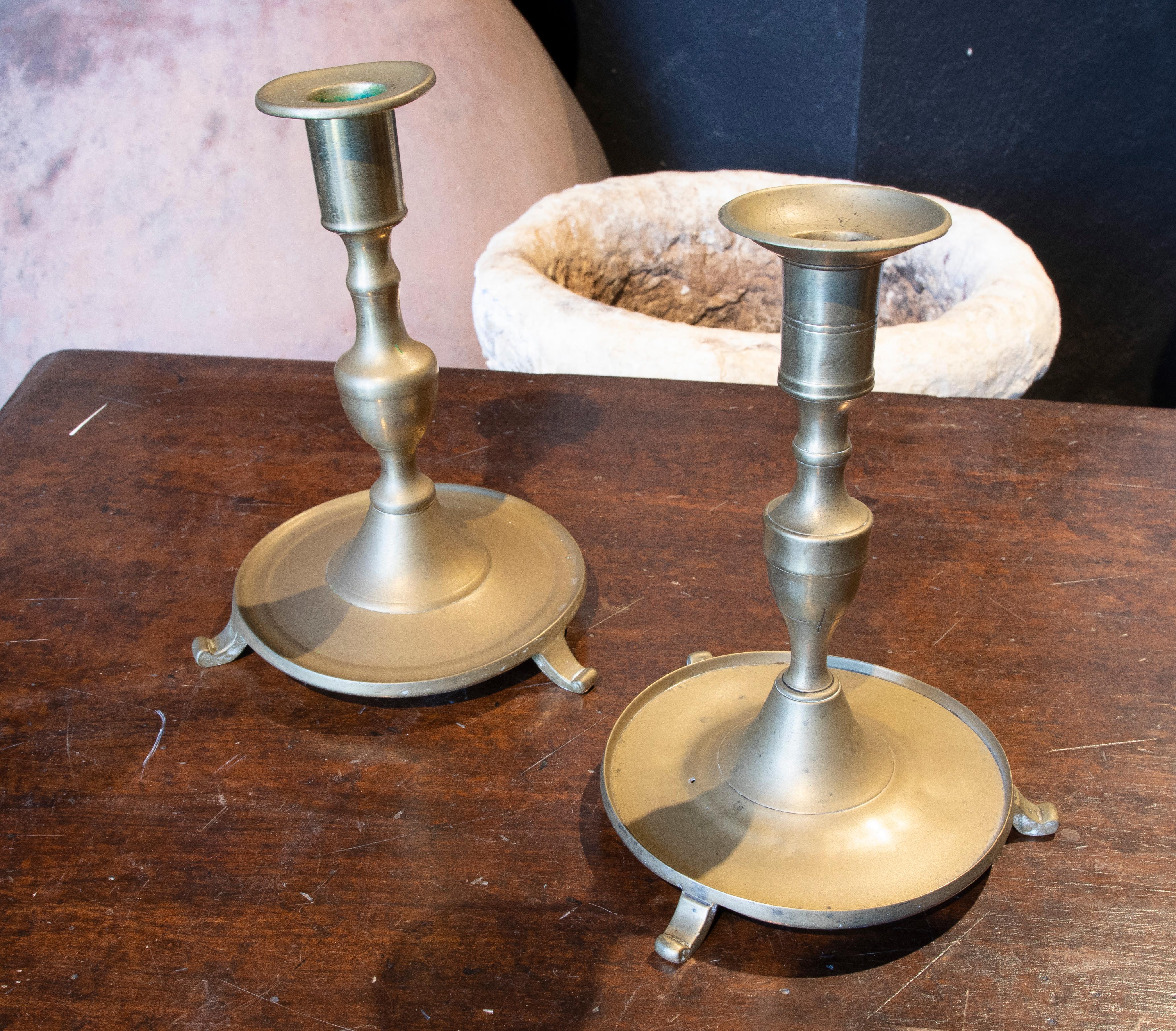Pair of Spanish bronze candlesticks with inscriptions on the bottom of the manufacturer and the city. 